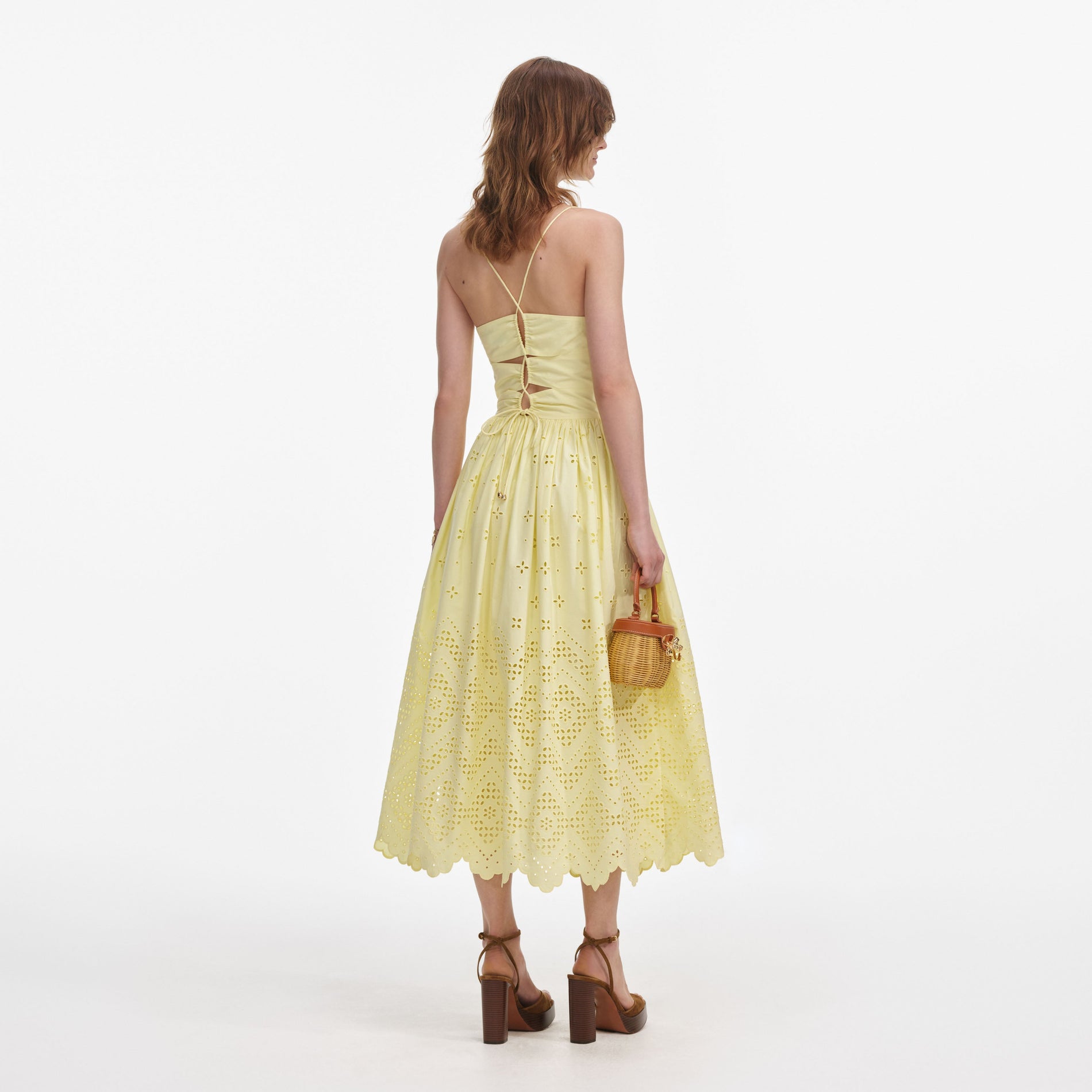 Back view of a woman wearing the Yellow Cotton Broderie Midi Dress
