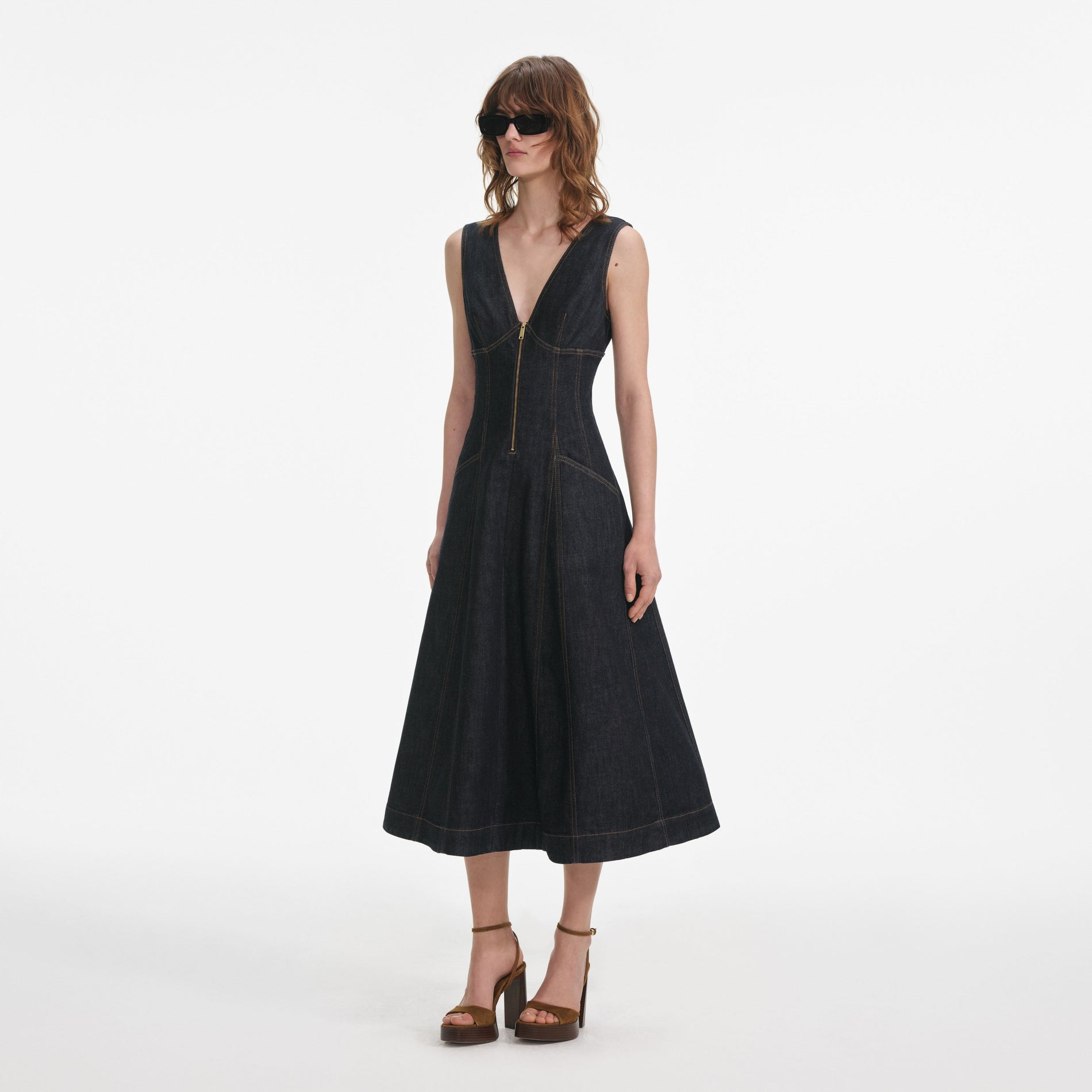 Side view of a woman wearing the Indigo Denim Midi Dress