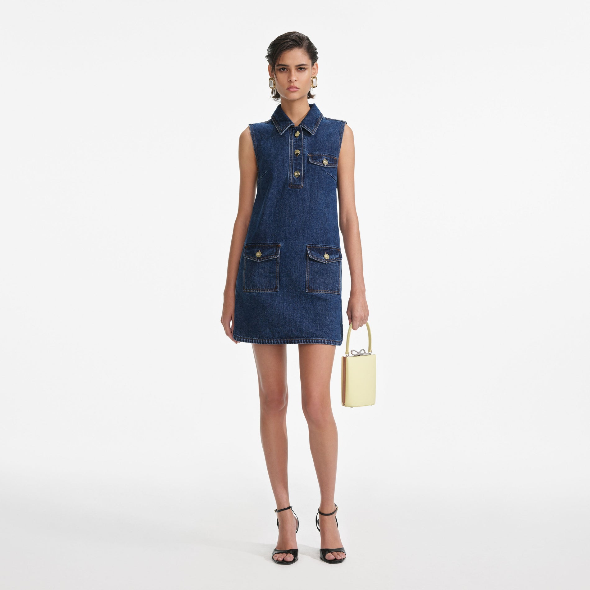 Front view of a woman wearing the Denim Sleeveless Mini Dress