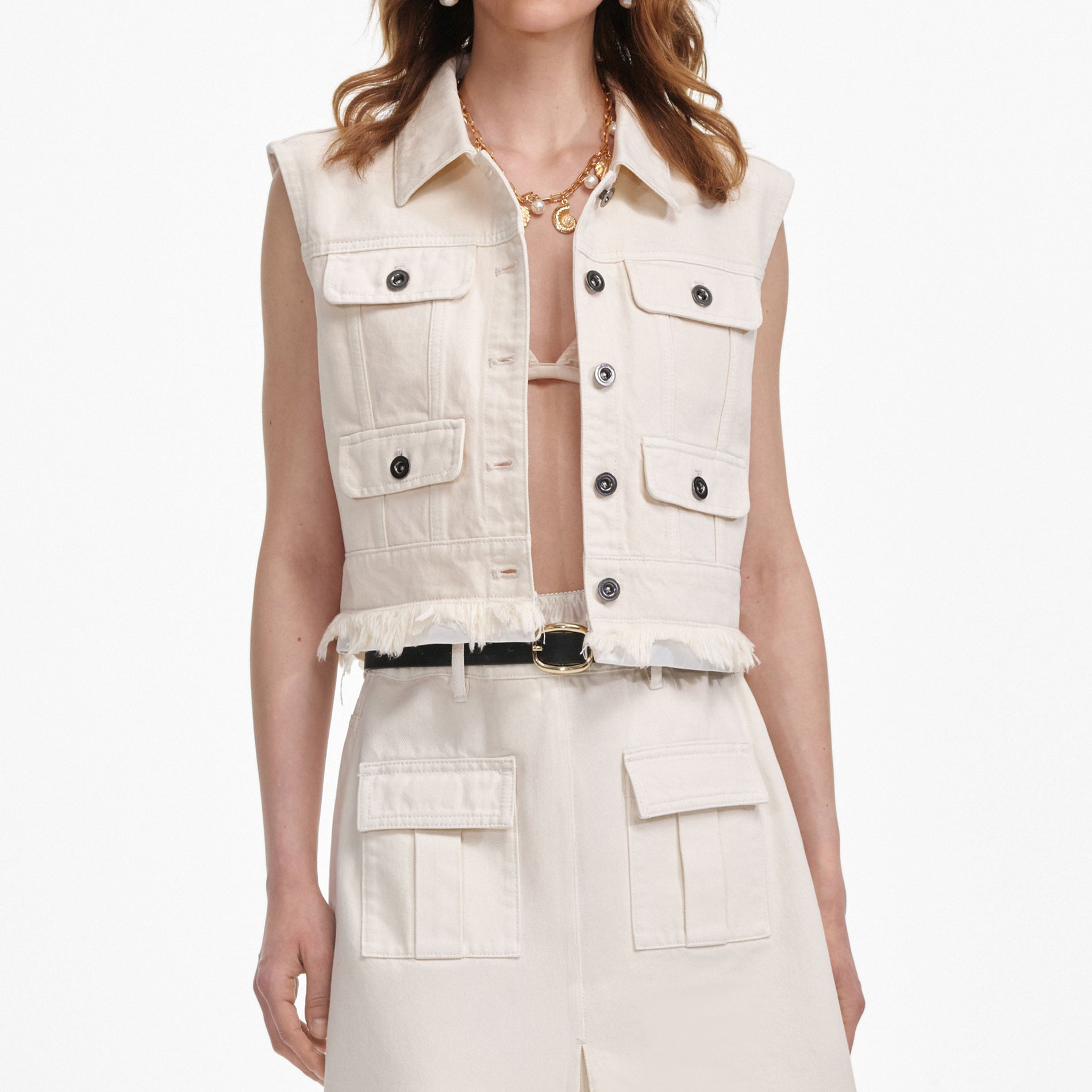 A close up of a woman wearing the Cream Denim Sleeveless Top