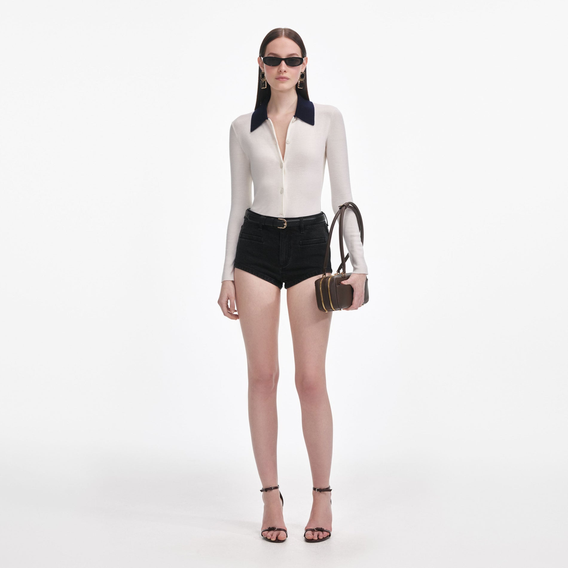 Front view of a woman wearing the Black Denim Shorts