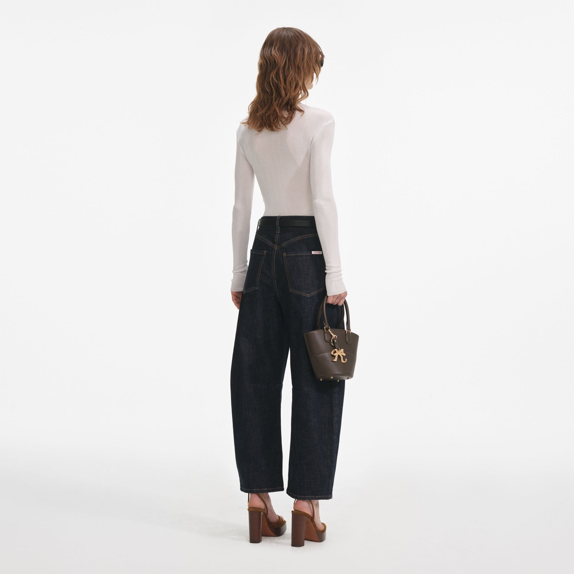 Back view of a woman wearing the Indigo Barrel Leg Jeans