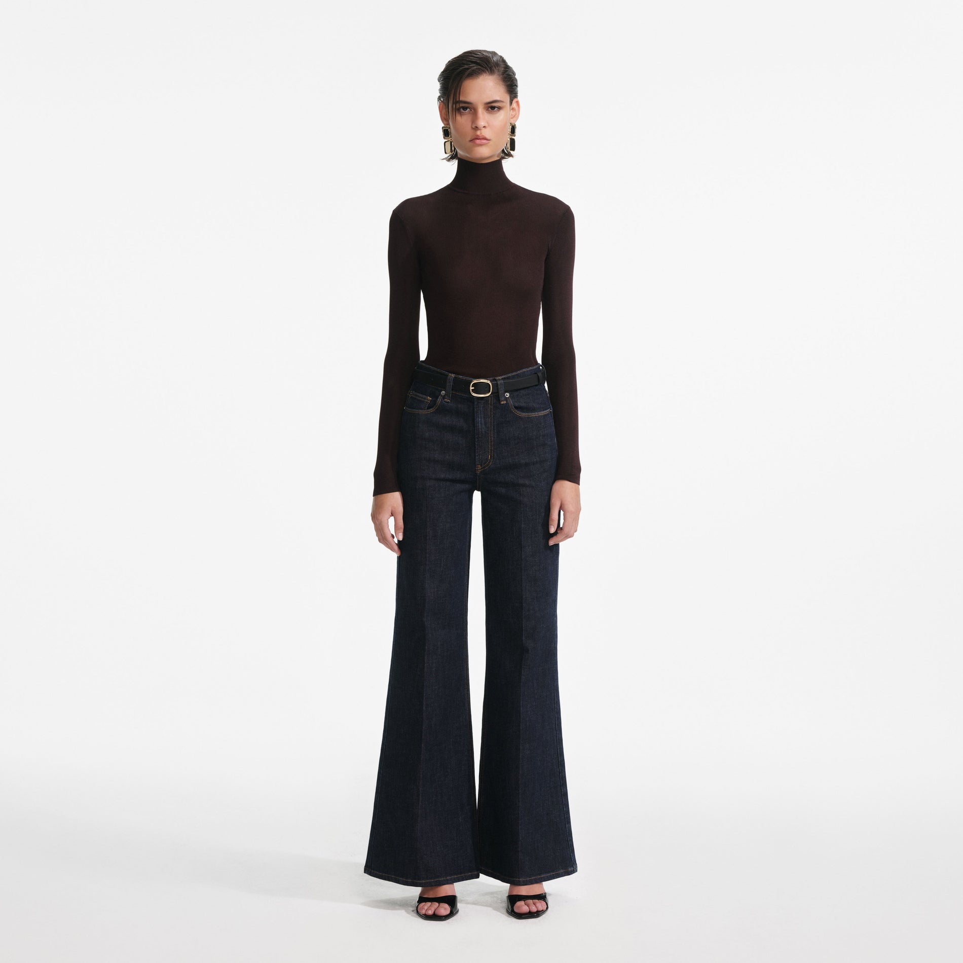 Front view of a woman wearing the Indigo Flared Jeans