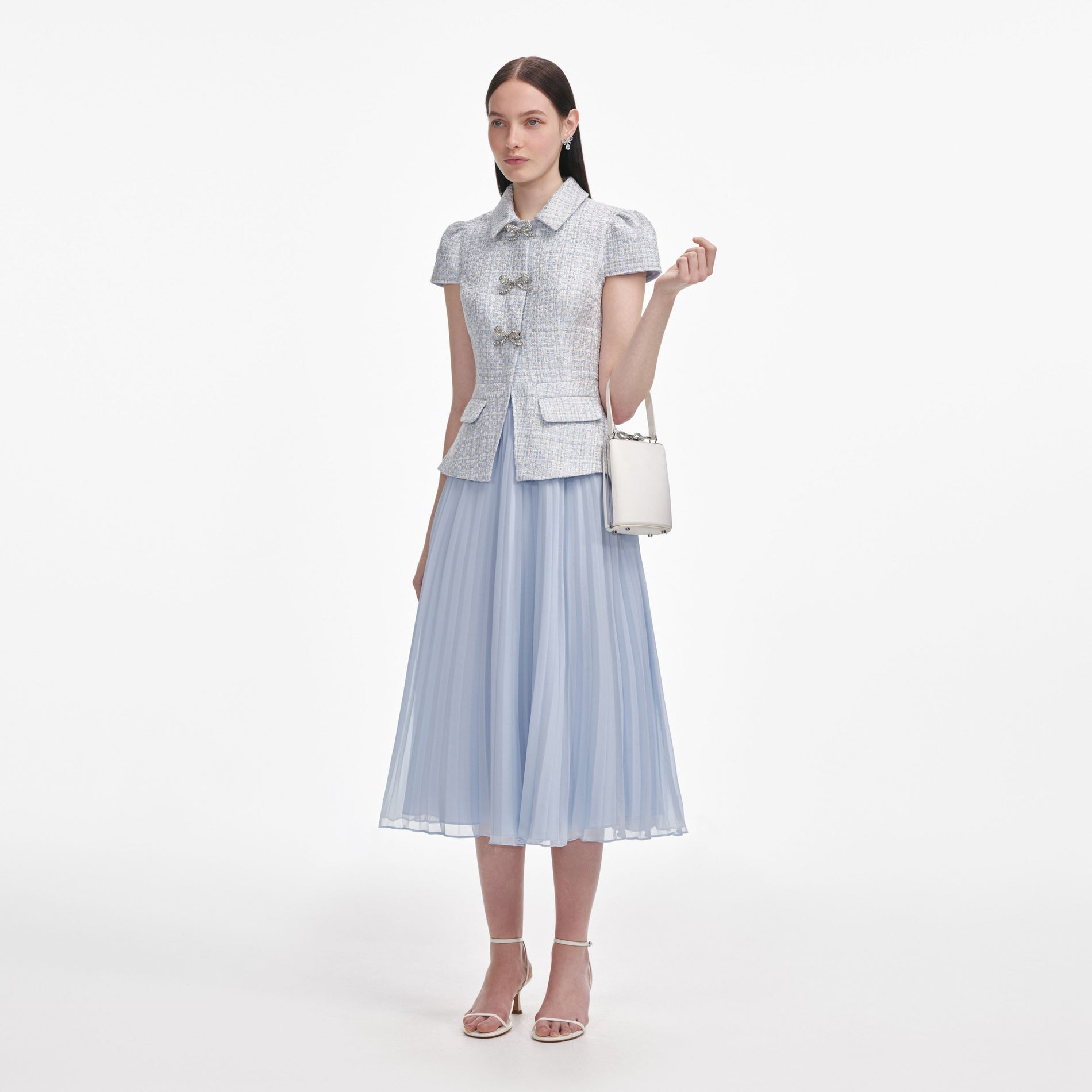 Side view of a woman wearing the Blue Boucle Bow Midi Dress