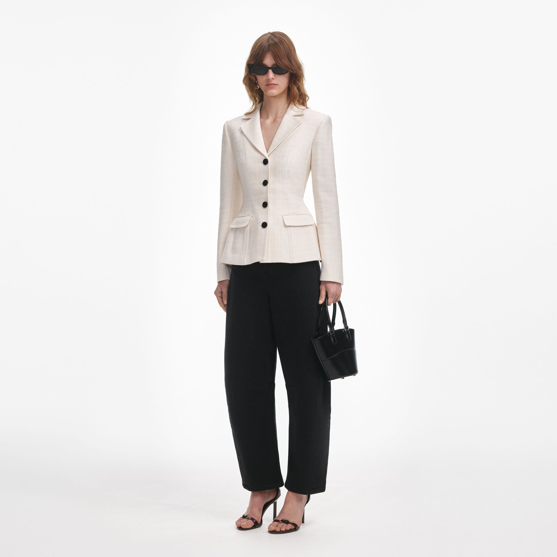 Side view of a woman wearing the Cream Boucle Jacket