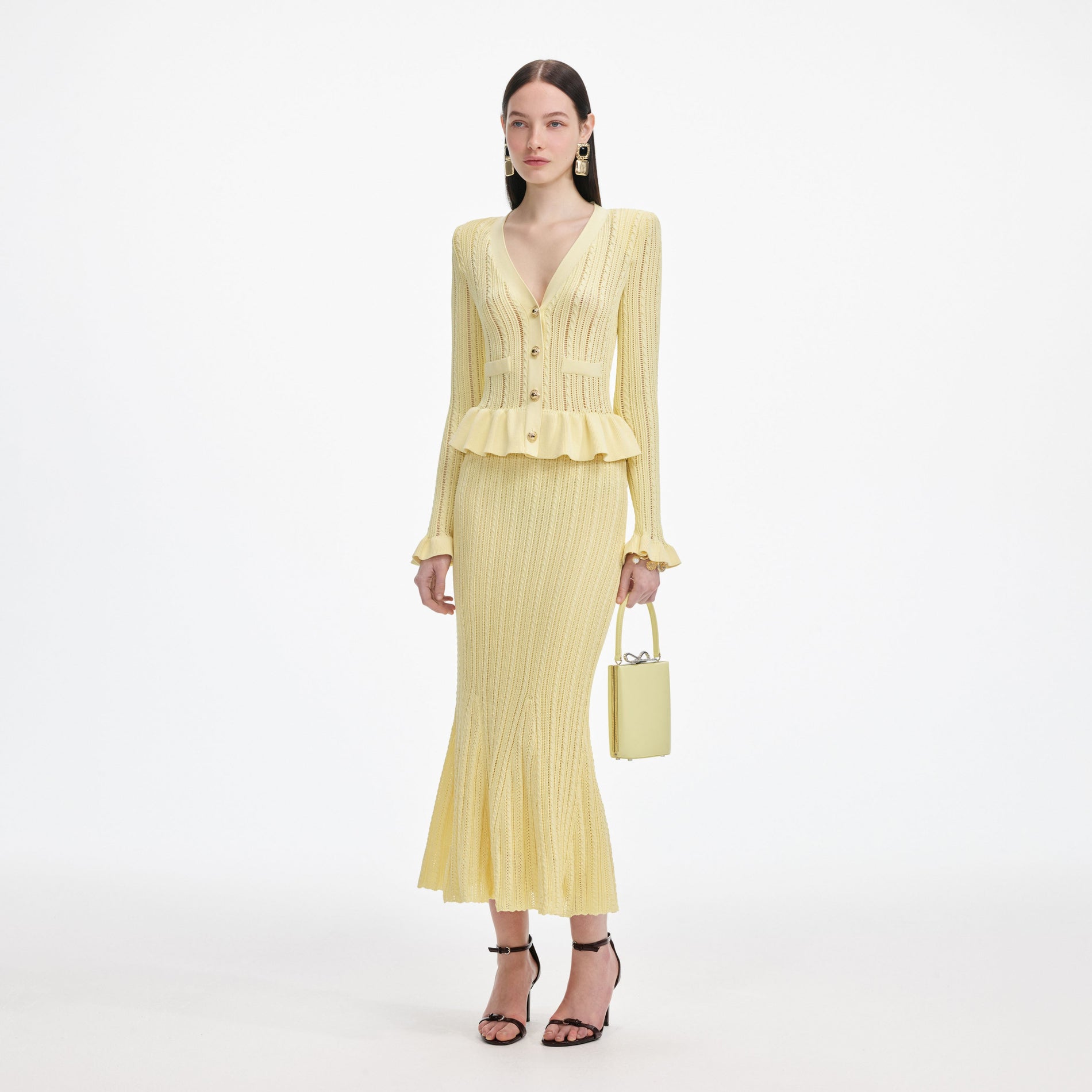 Side view of a woman wearing the Yellow Knit Peplum Midi Dress