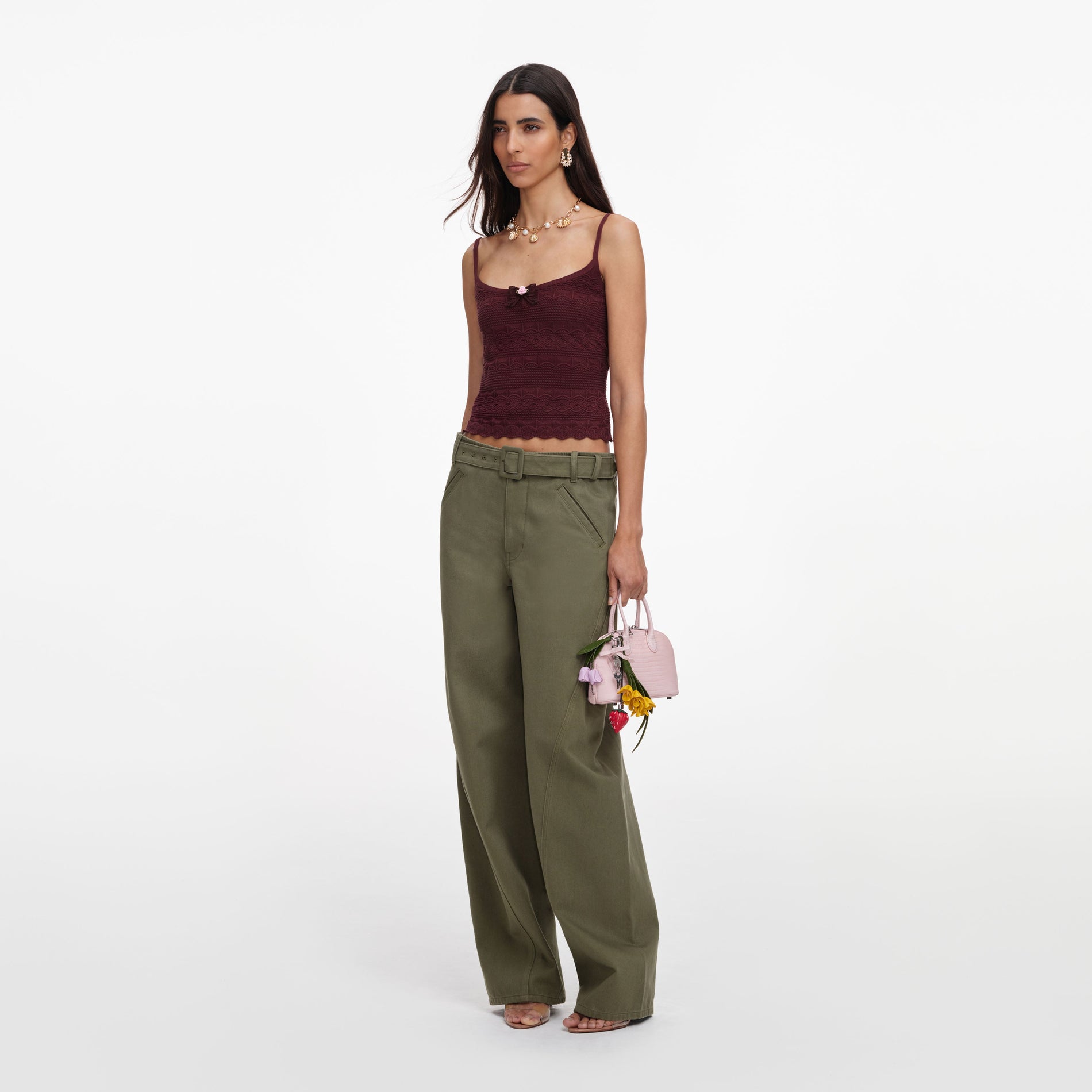 Side view of a woman wearing the Brown Pointelle Knit Vest