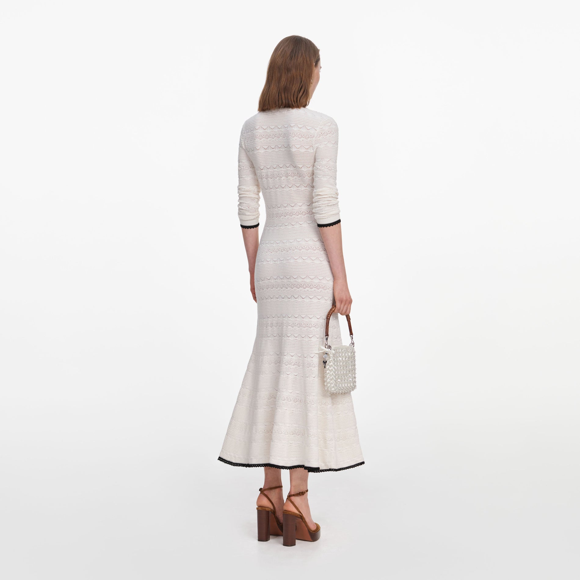 Back view of a woman wearing the White Pointelle Knit Long Cardigan