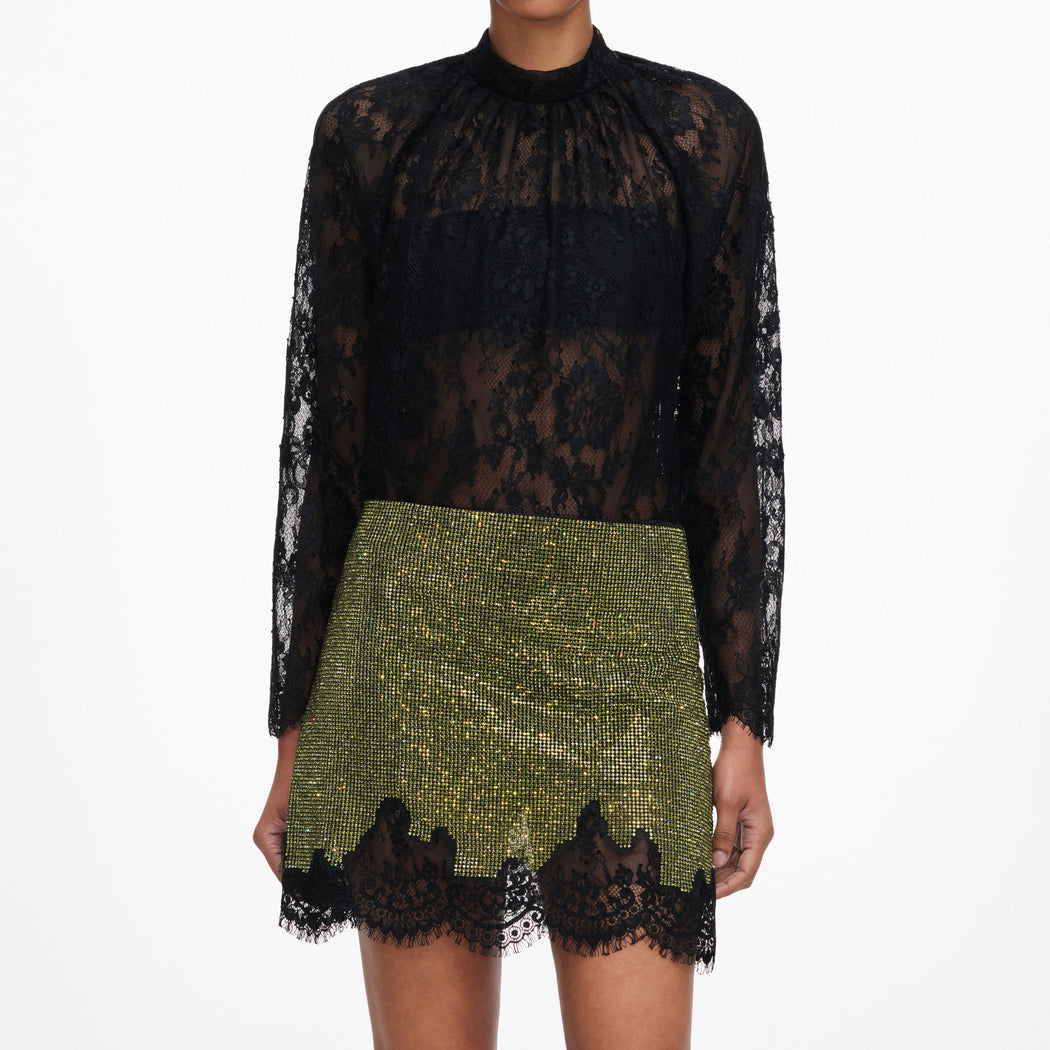 A close up of a woman wearing the Green Crystal Chainmail Mini Skirt