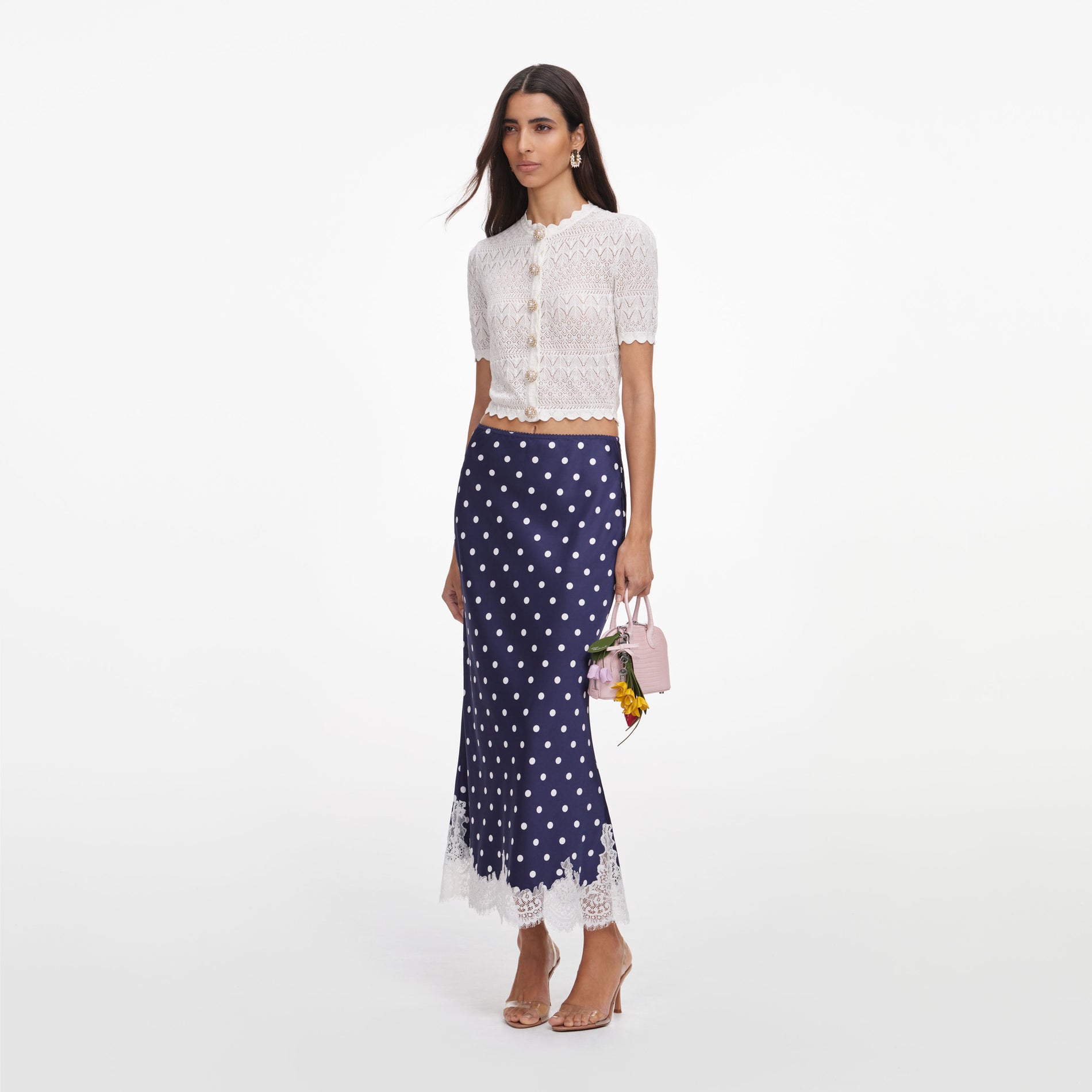 Side view of a woman wearing the White Pointelle Knit Top