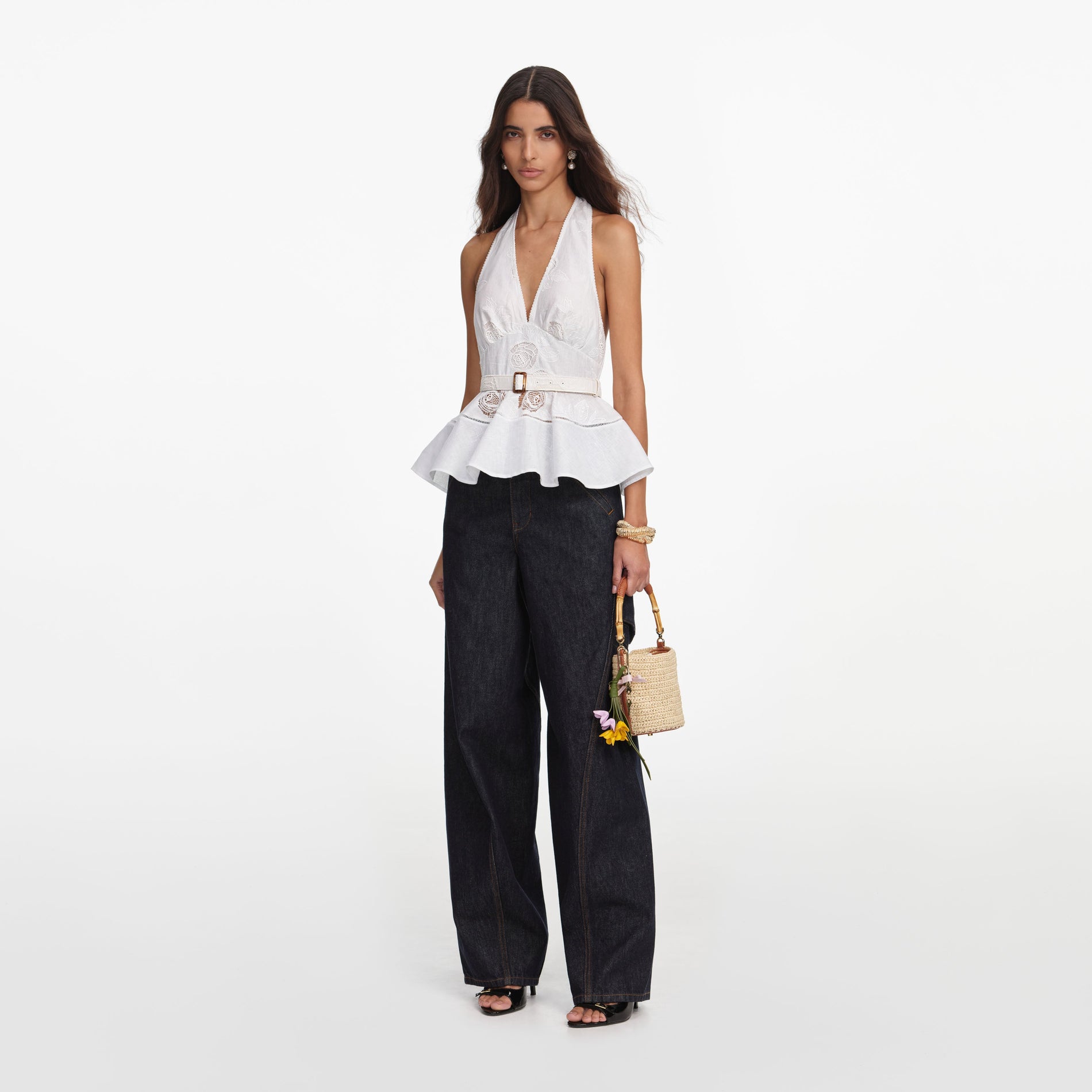 Side view of a woman wearing the White Linen Blend Peplum Top