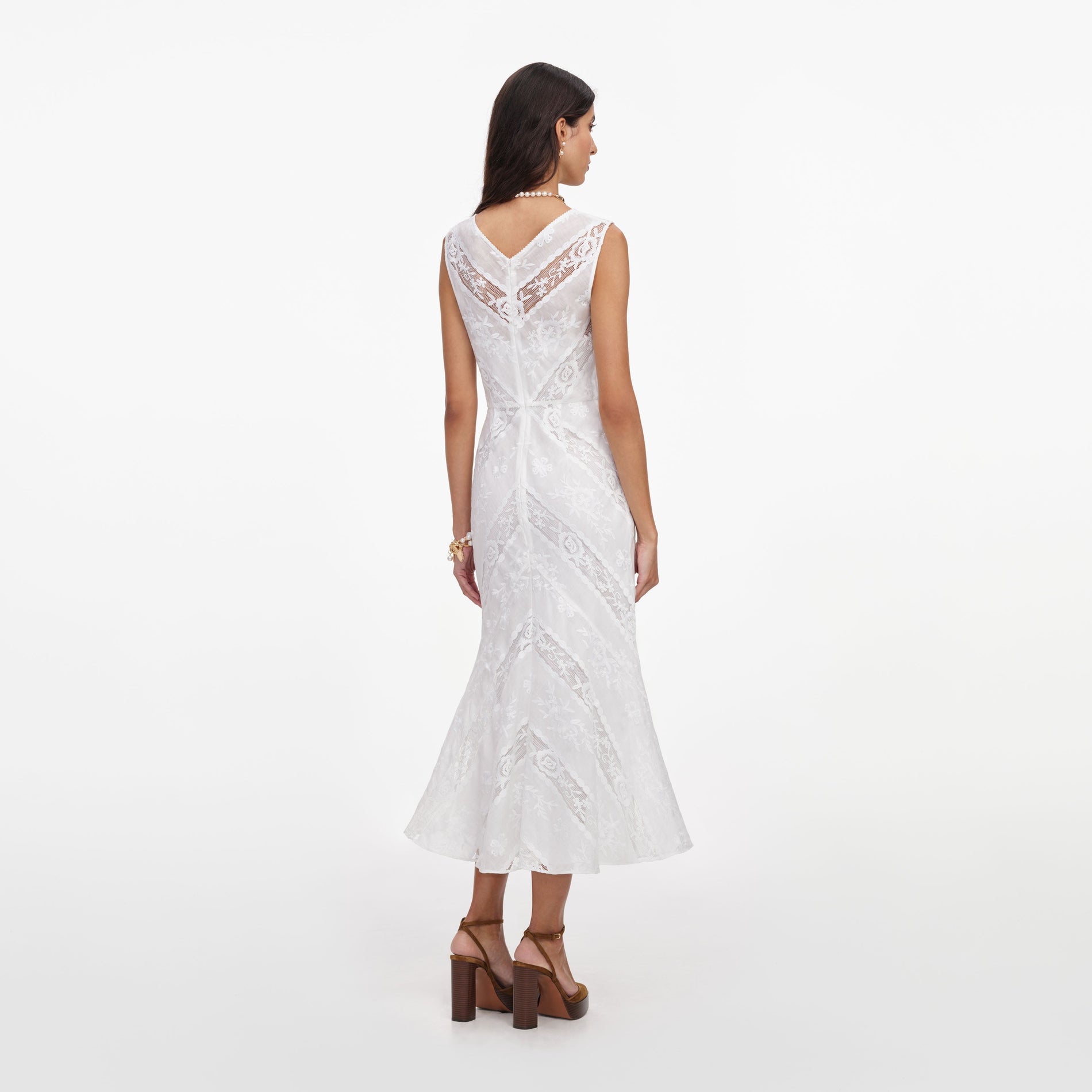 Back view of a woman wearing the White Ramie Sleeveless Midi Dress