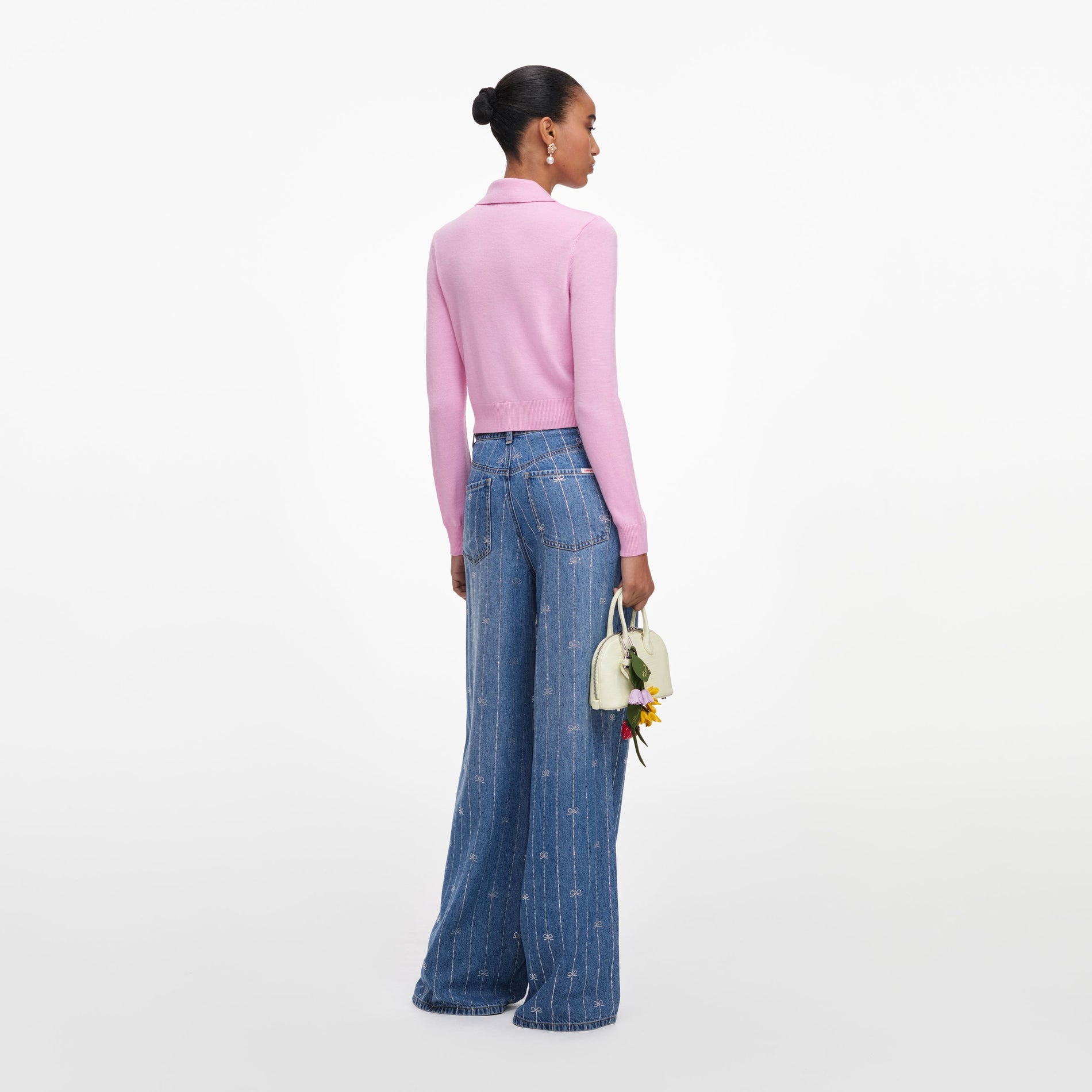 Back view of a woman wearing the Pink Flower Embroidered Knit Cardigan