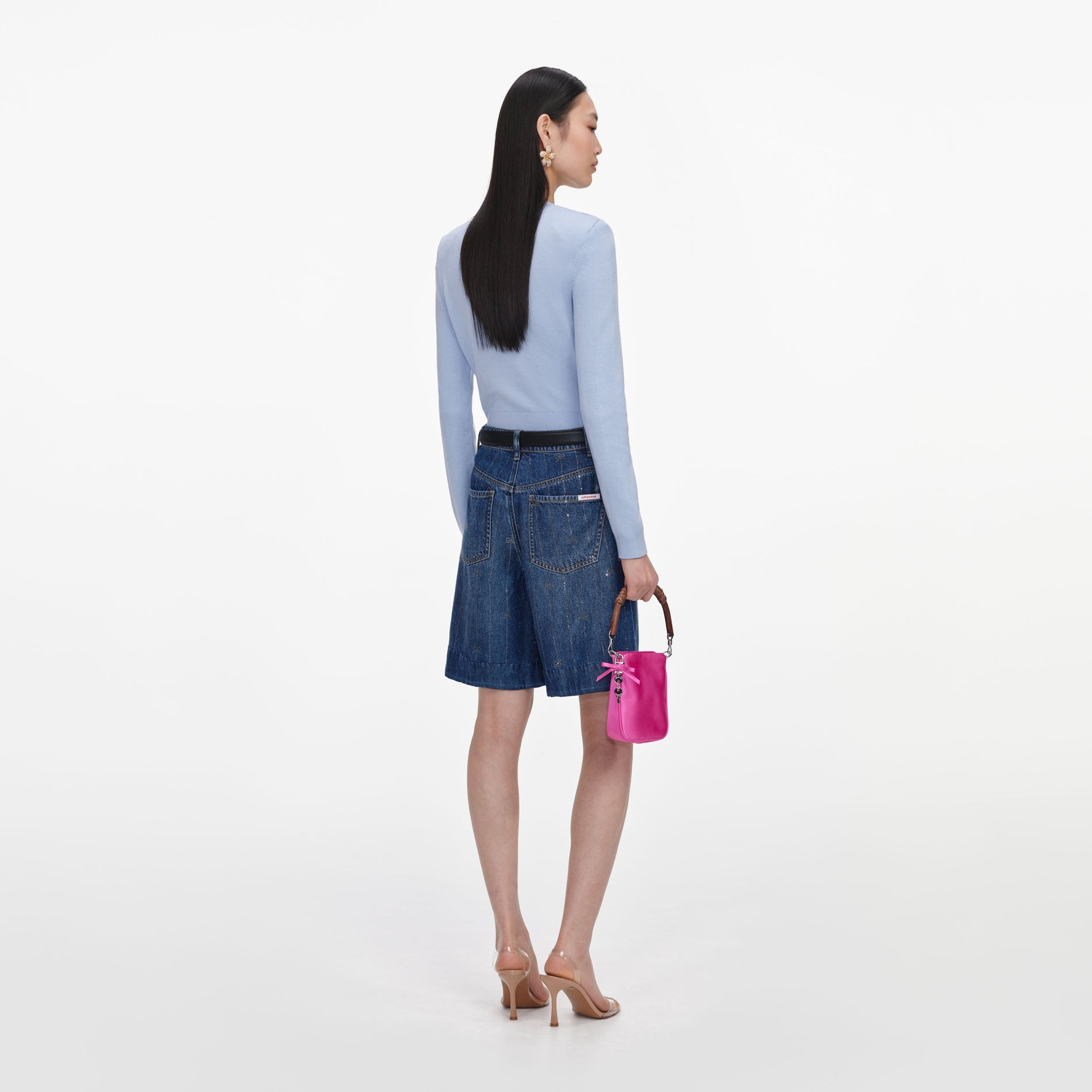 Back view of a woman wearing the Rhinestone Stripe Denim Shorts