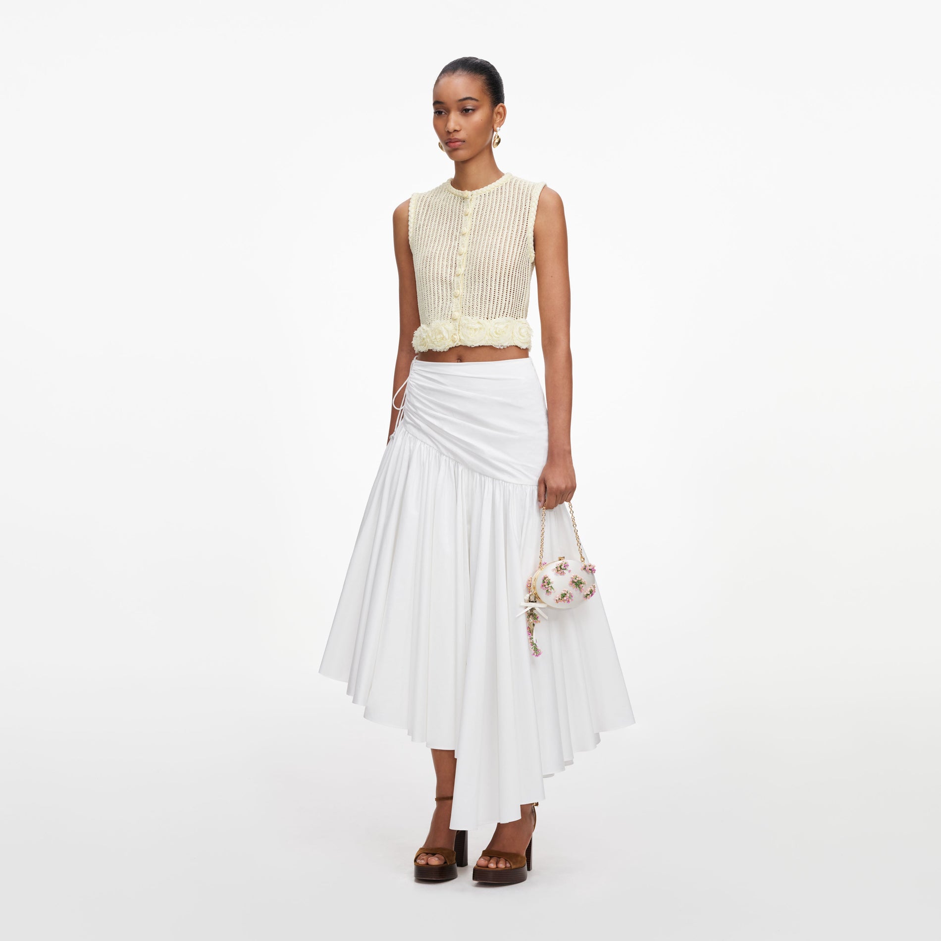 Side view of a woman wearing the Yellow Crochet Flower Knit Top