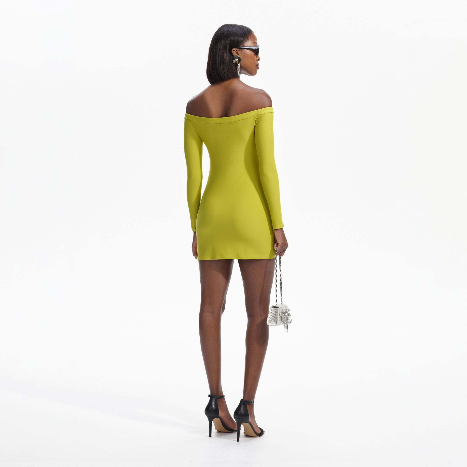 Back view of a woman wearing the Chartreuse Off Shoulder Mini Dress