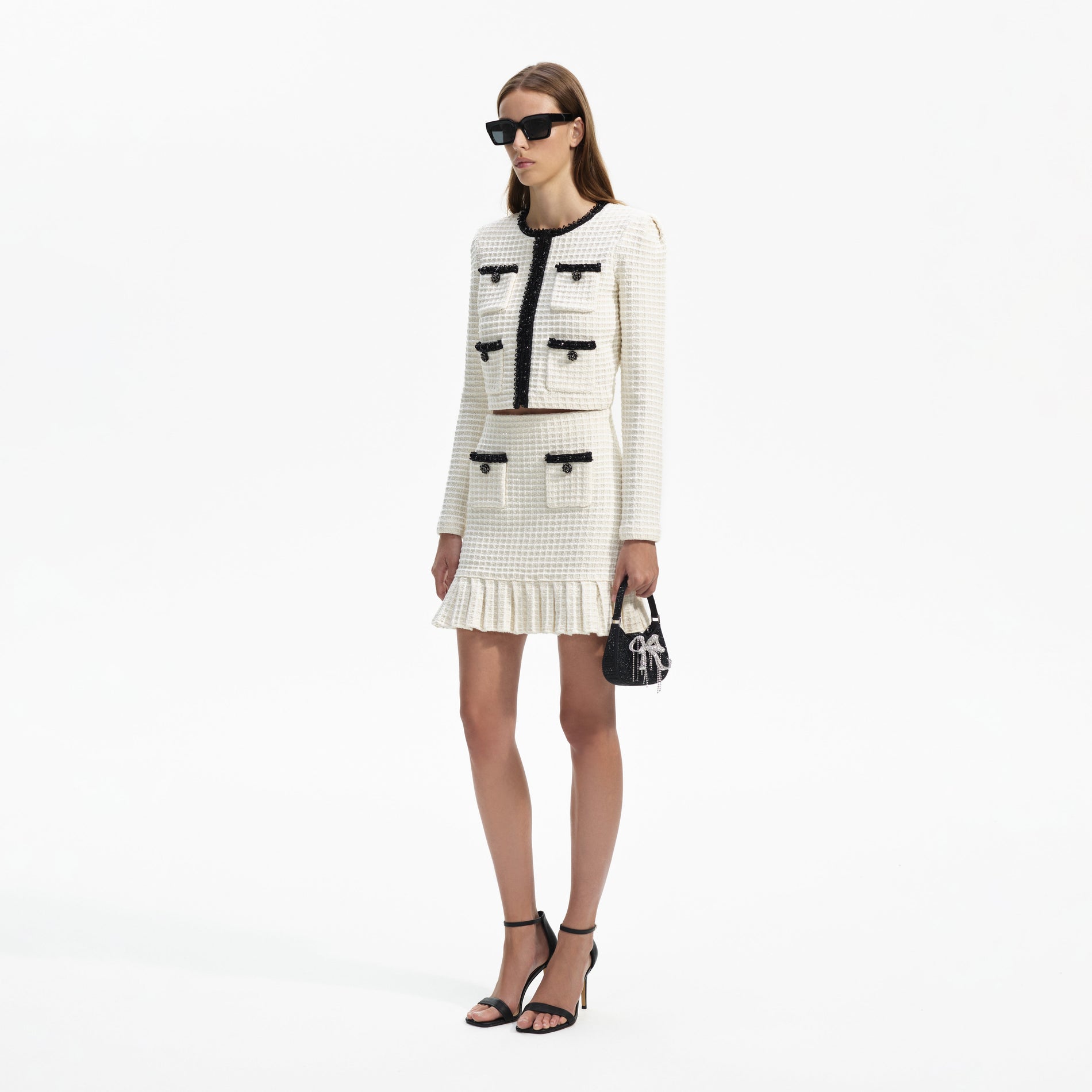 Side view of a woman wearing the Cream Textured Knit Mini Skirt