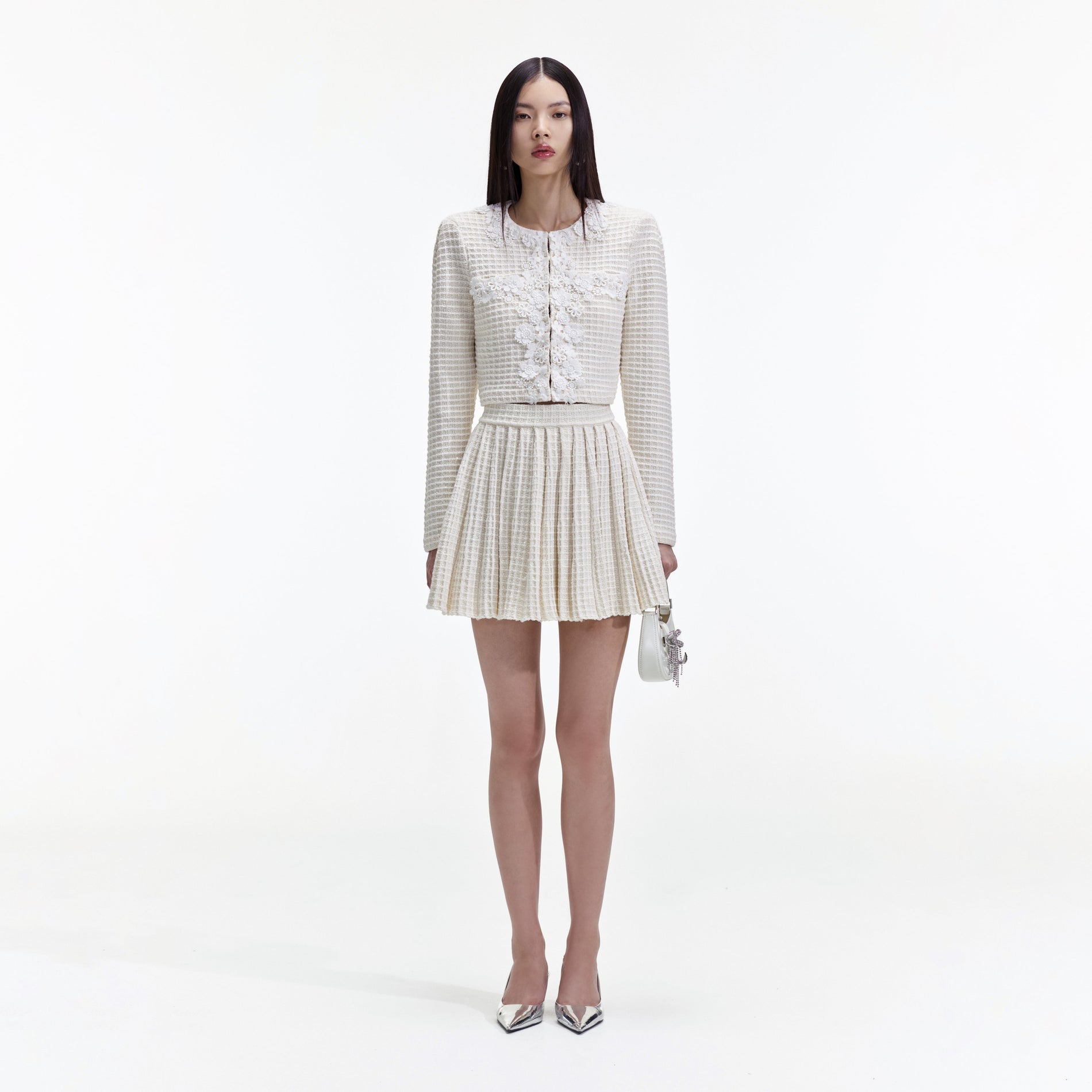 Front view of a woman wearing the Cream Knitted Mini Skirt