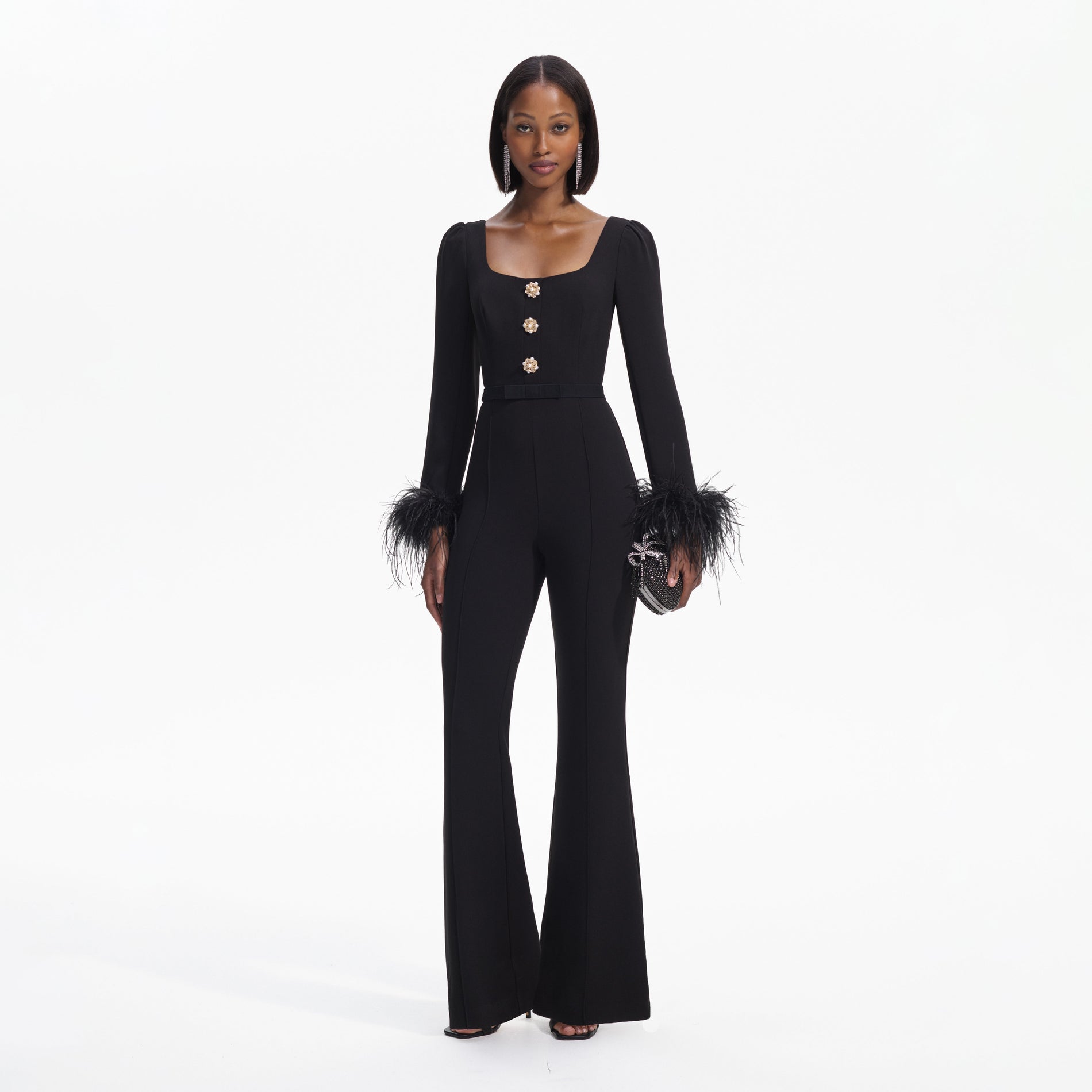 Front view of a woman wearing the Black Crepe Feather Jumpsuit