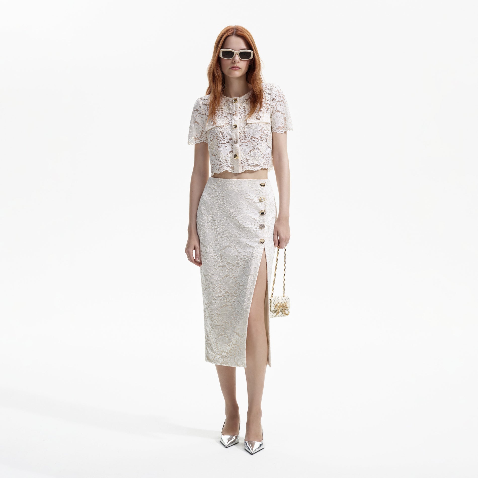 Front view of a woman wearing the Cream Cord Lace Split Midi Skirt