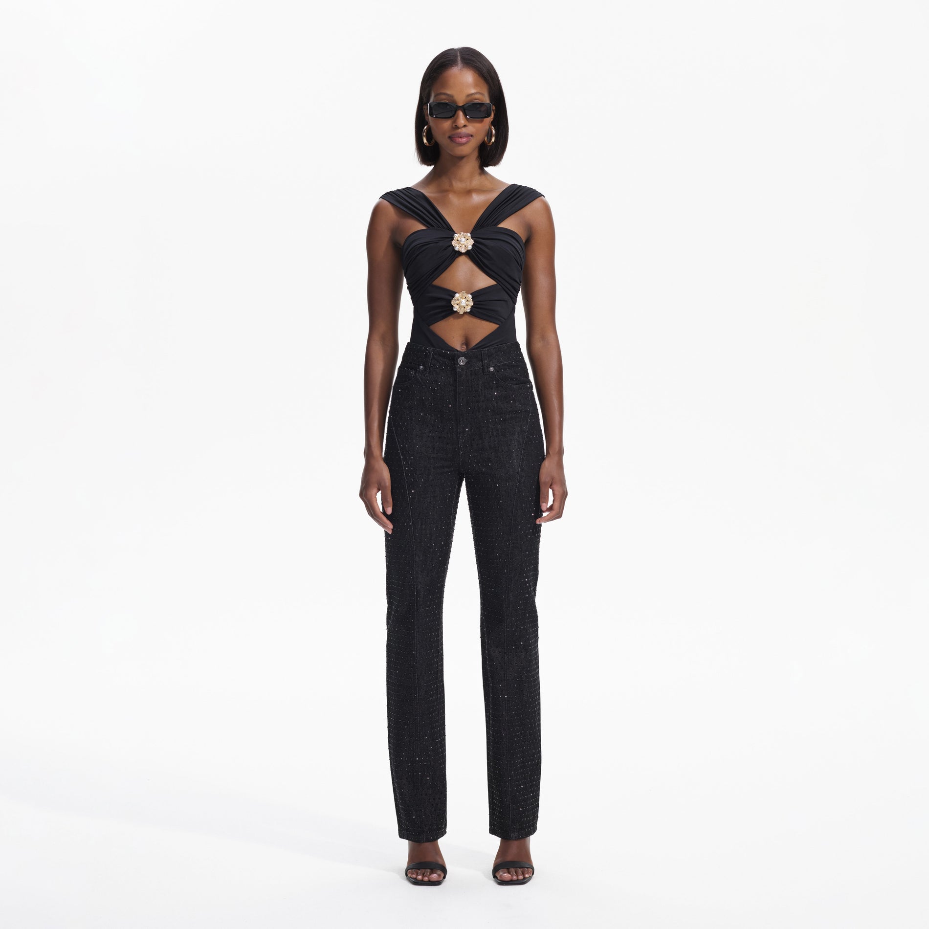 Front view of a woman wearing the Black Rhinestone Denim Jeans