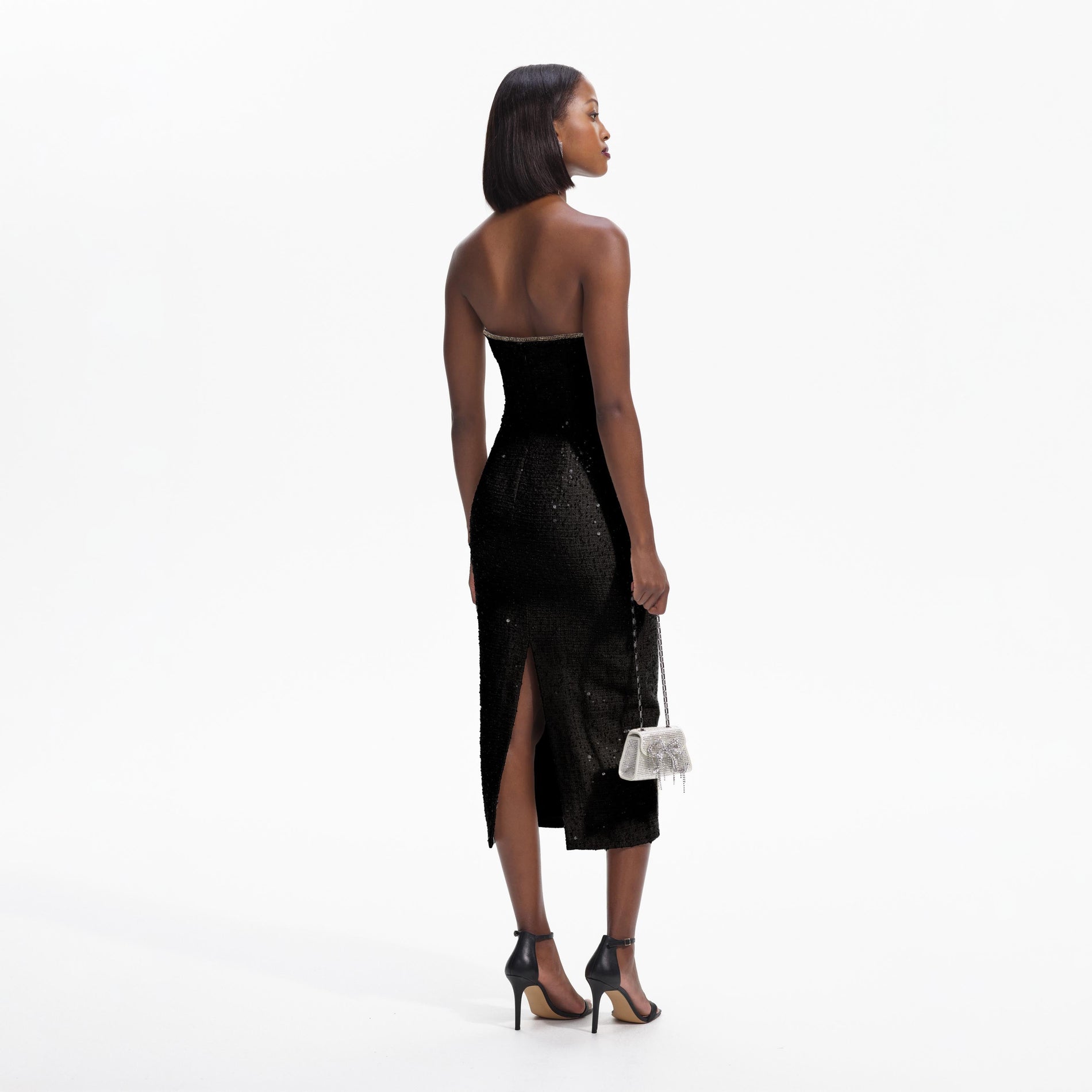 Back view of a woman wearing the Black Sequin Boucle Midi Dress