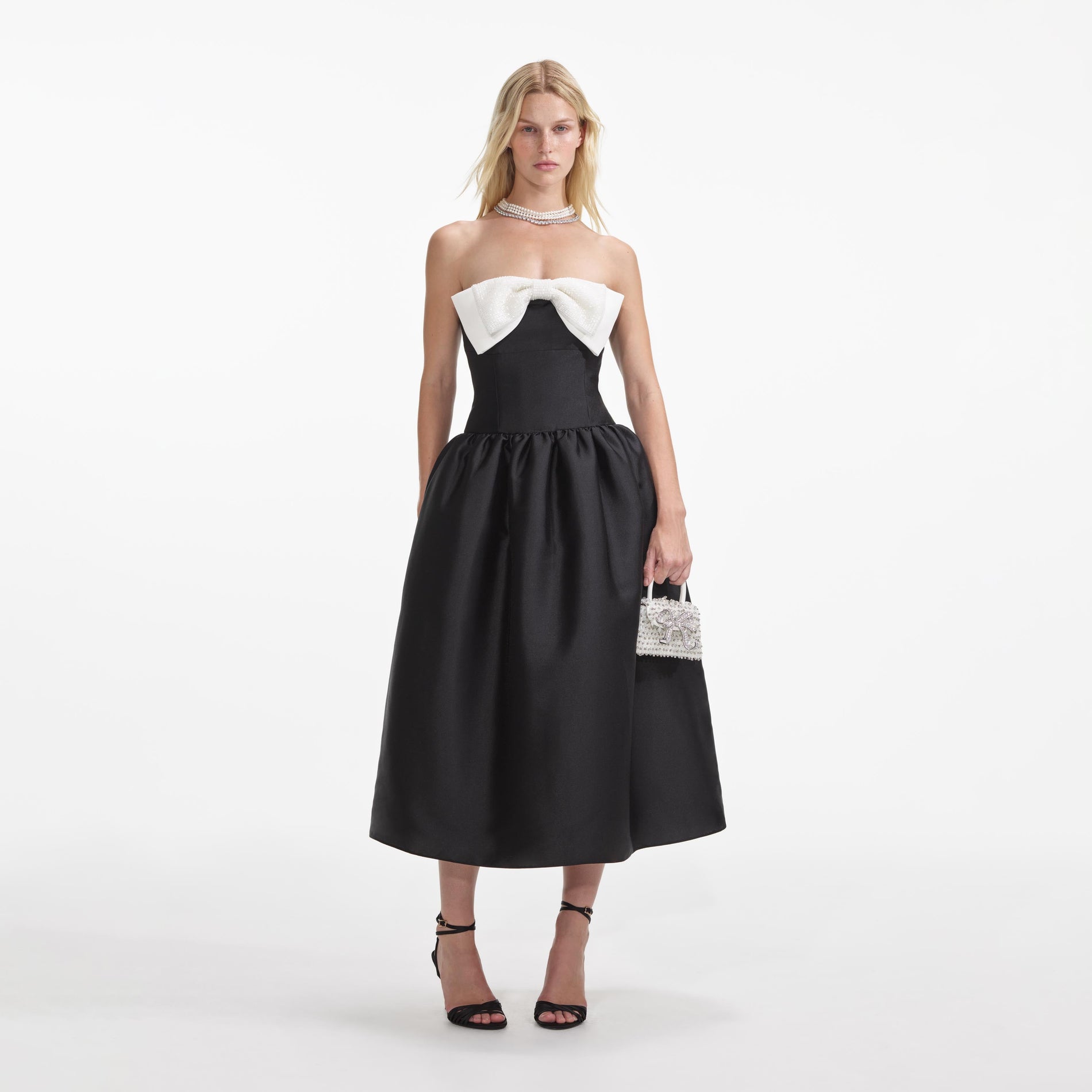 Front view of a woman wearing the Black Taffeta Contrast Bow Midi Dress
