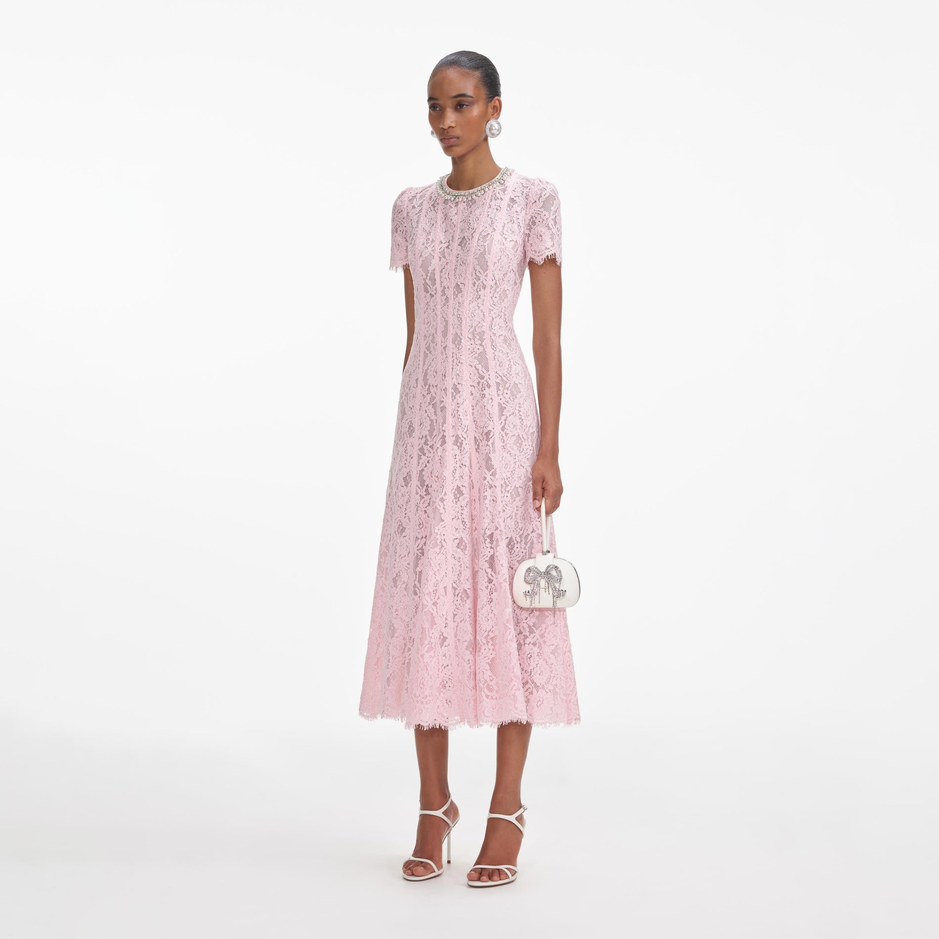 Side view of a woman wearing the Pink Lace Embellished Midi Dress
