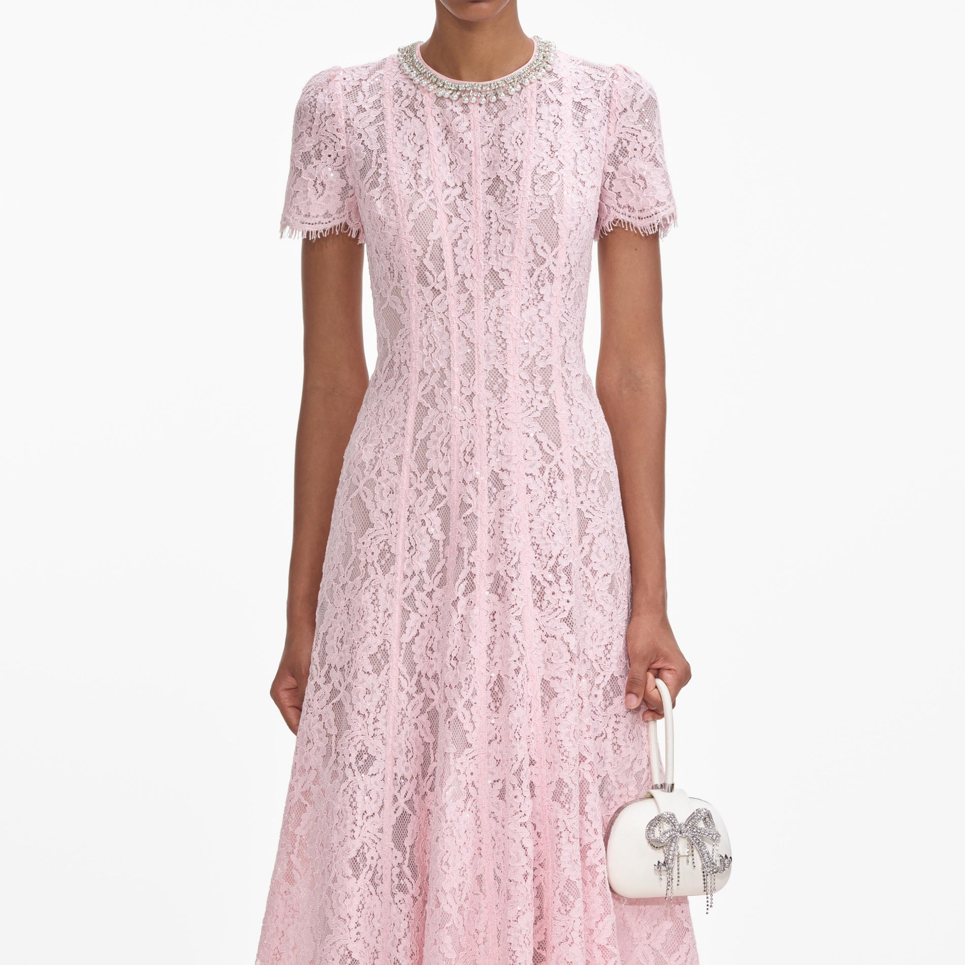 A close up of a woman wearing the Pink Lace Embellished Midi Dress
