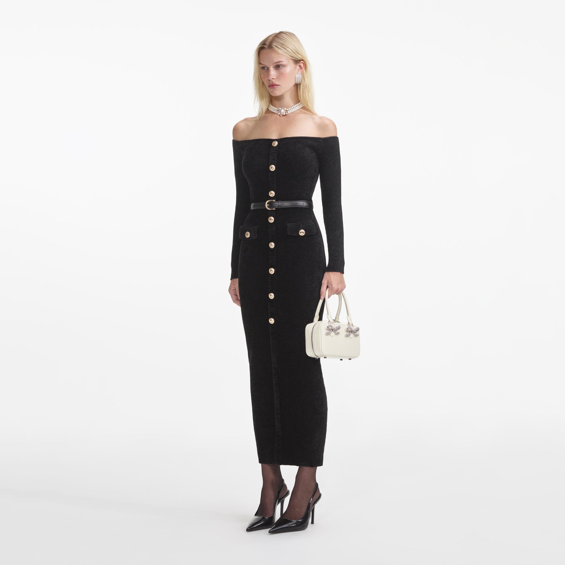 Side view of a woman wearing the Black Chenille Knit Midi Dress