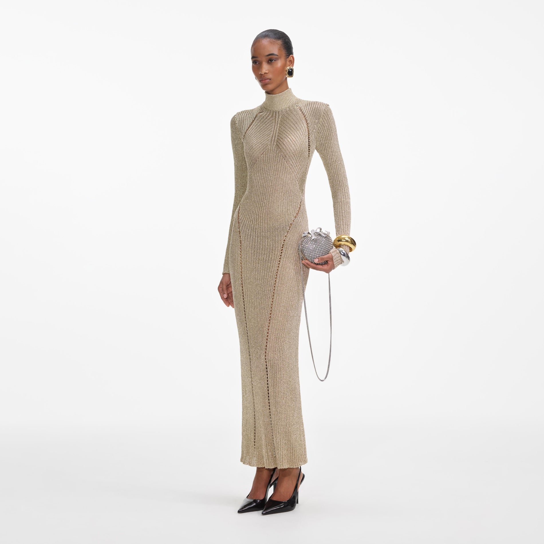 Side view of a woman wearing the Gold Lurex Knit Maxi Dress