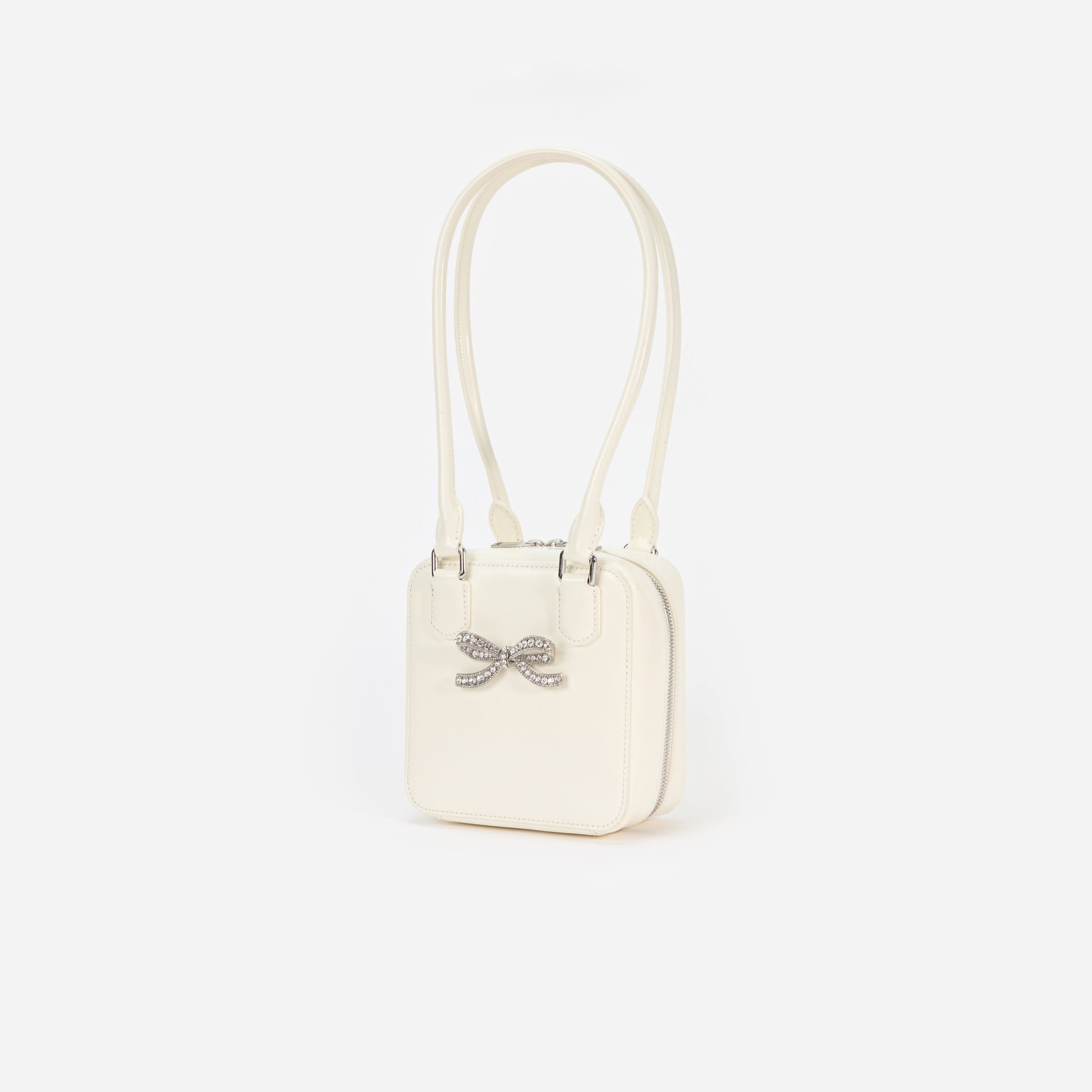 Side view of a woman wearing the Cream Leather Square Shoulder Bag