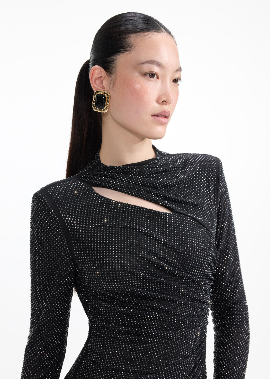 A close up of a woman wearing the Mottled Gold Black Earrings