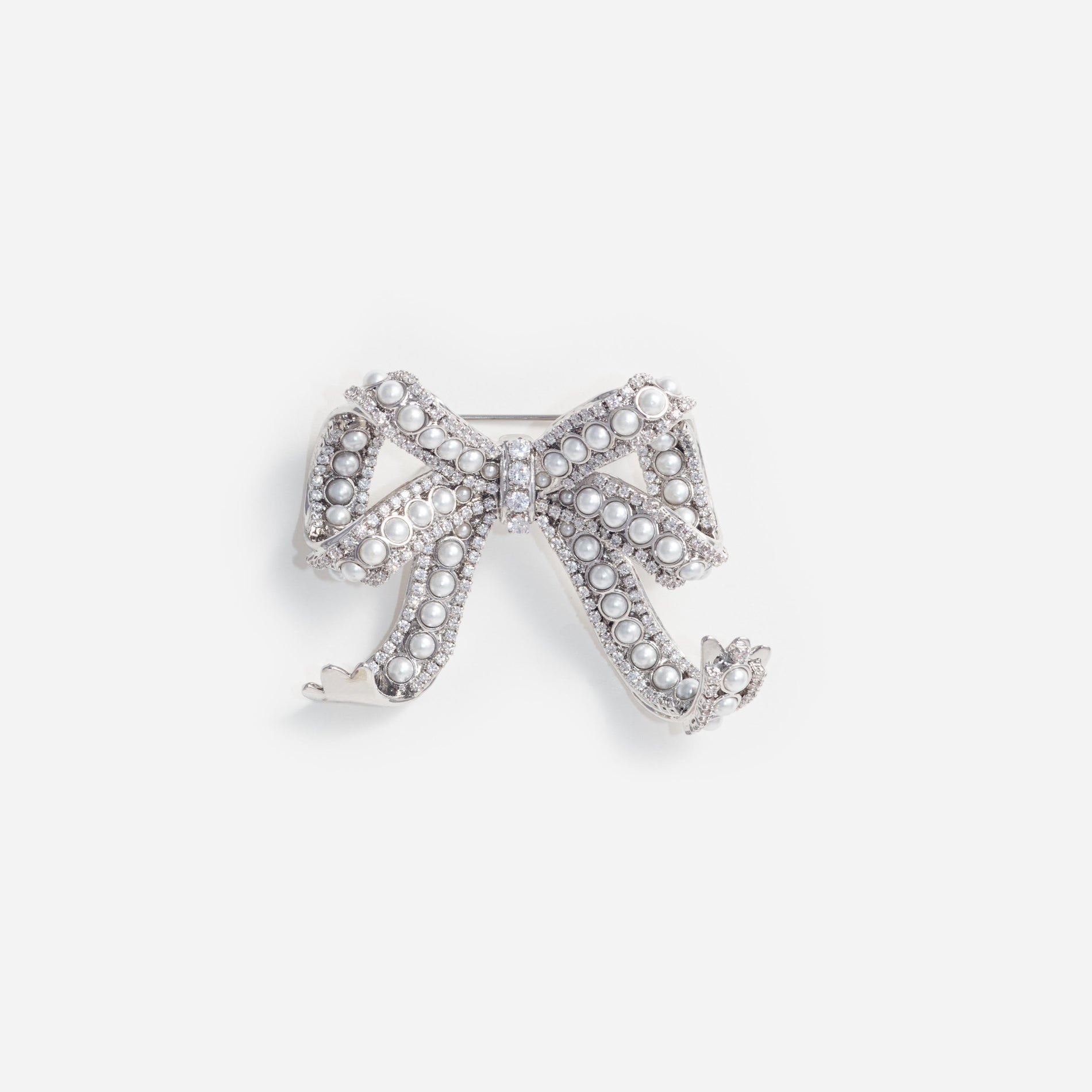 Front view of a woman wearing the Pearl Crystal Bow Brooch