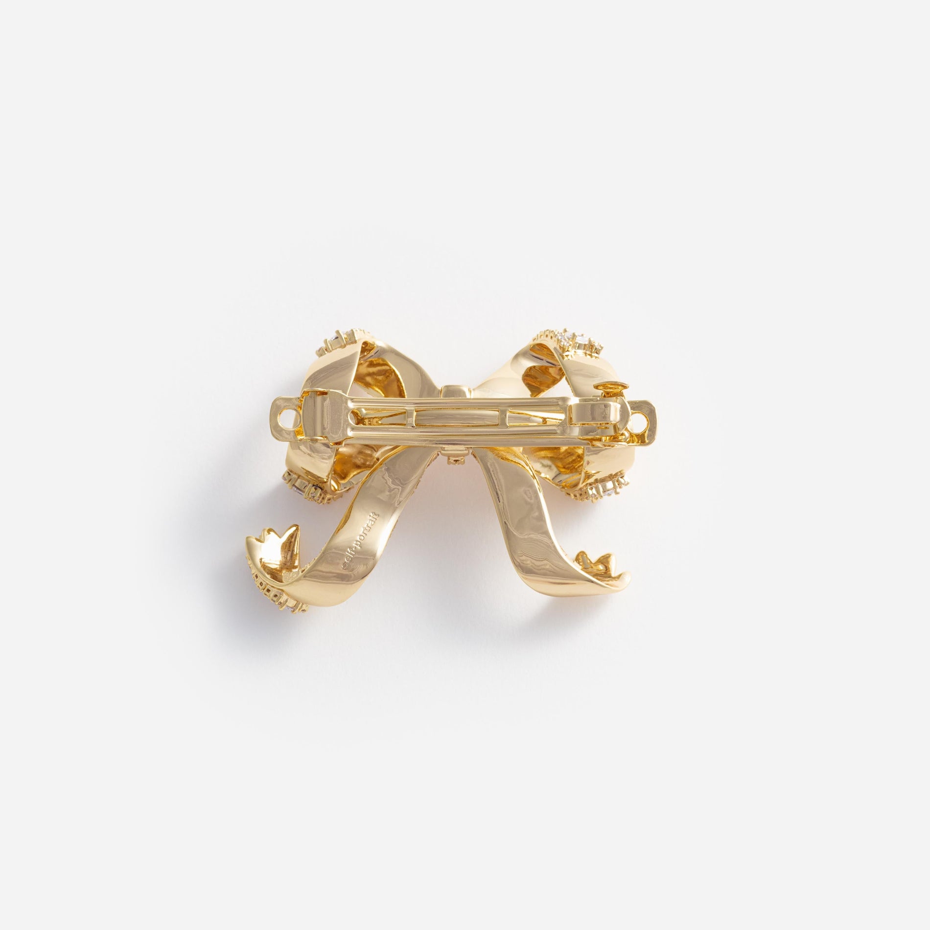 Side view of a woman wearing the Gold Crystal Bow Hair Clip