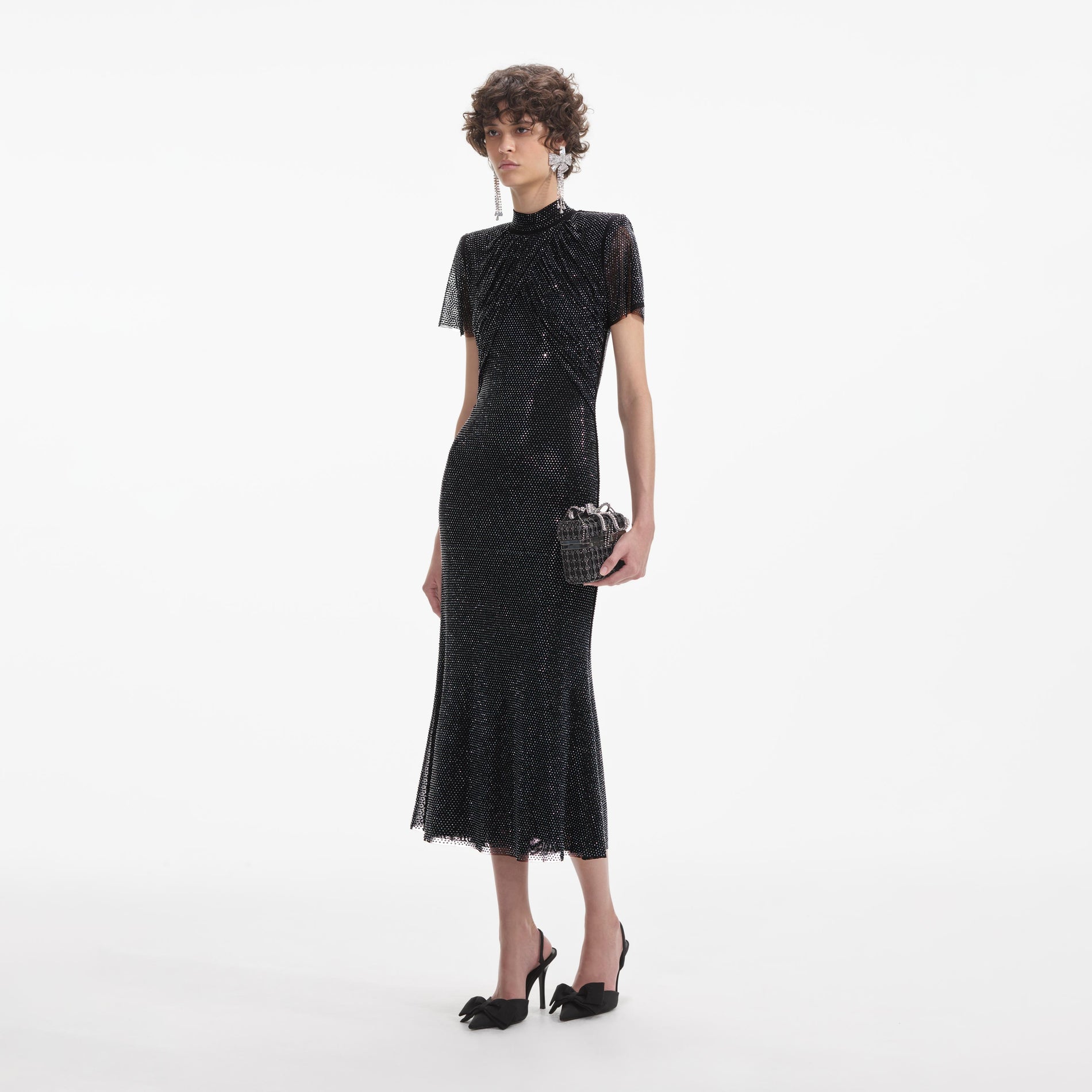 Side view of a woman wearing the Black Rhinestone Mesh Midi Dress