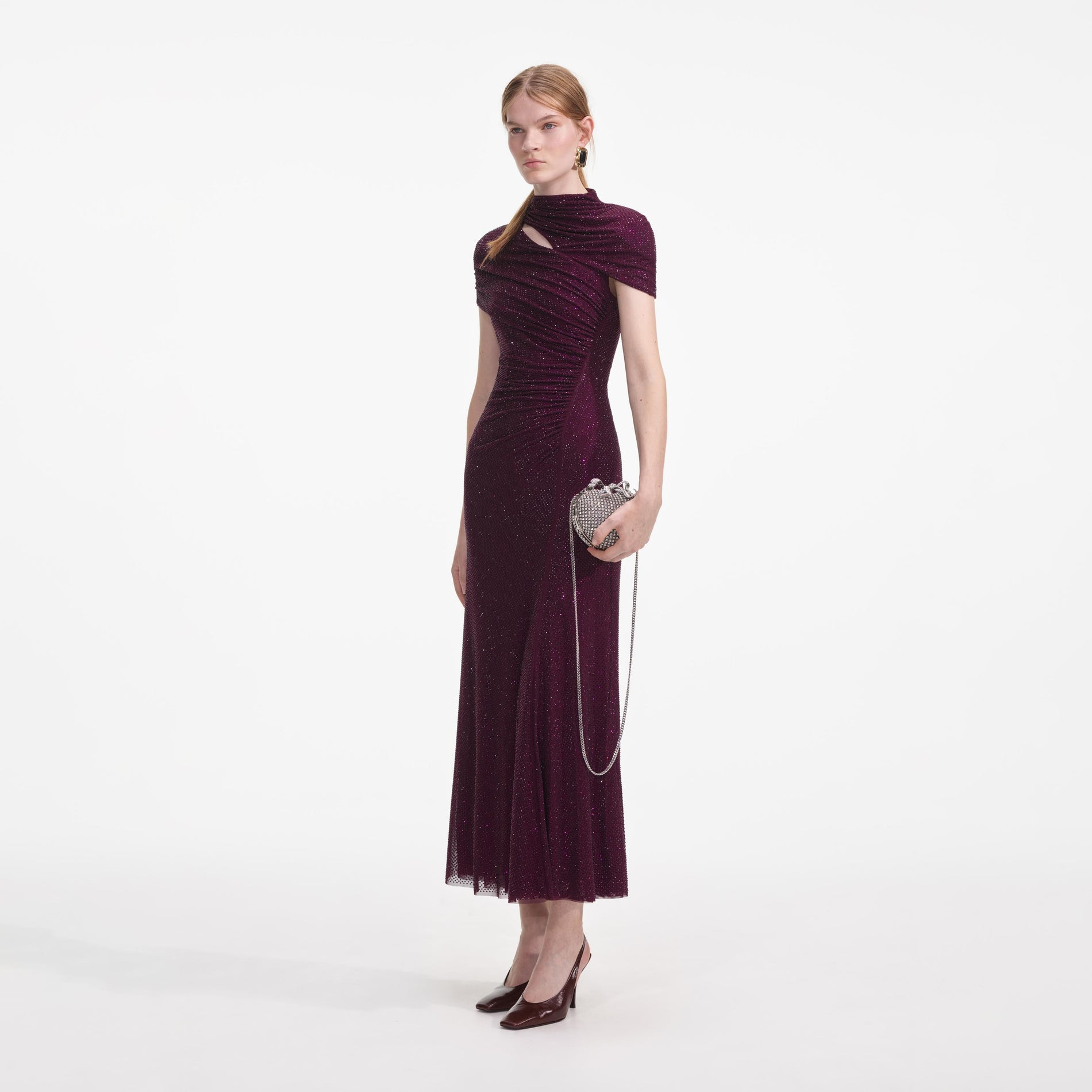 Side view of a woman wearing the Burgundy Rhinestone Mesh Cut Out Midi Dress