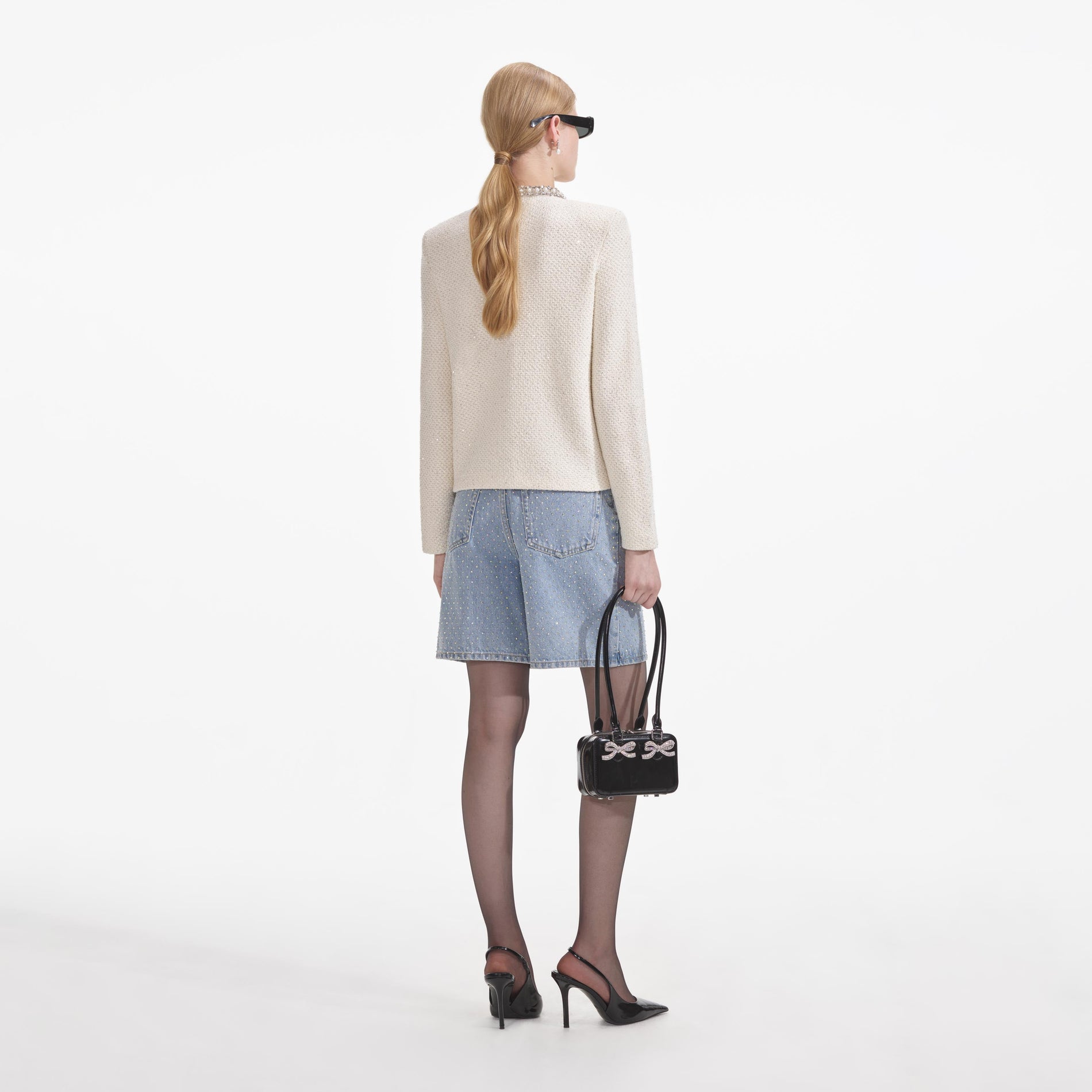 A close up of a woman wearing the Cream Textured Knit Embellished Cardigan