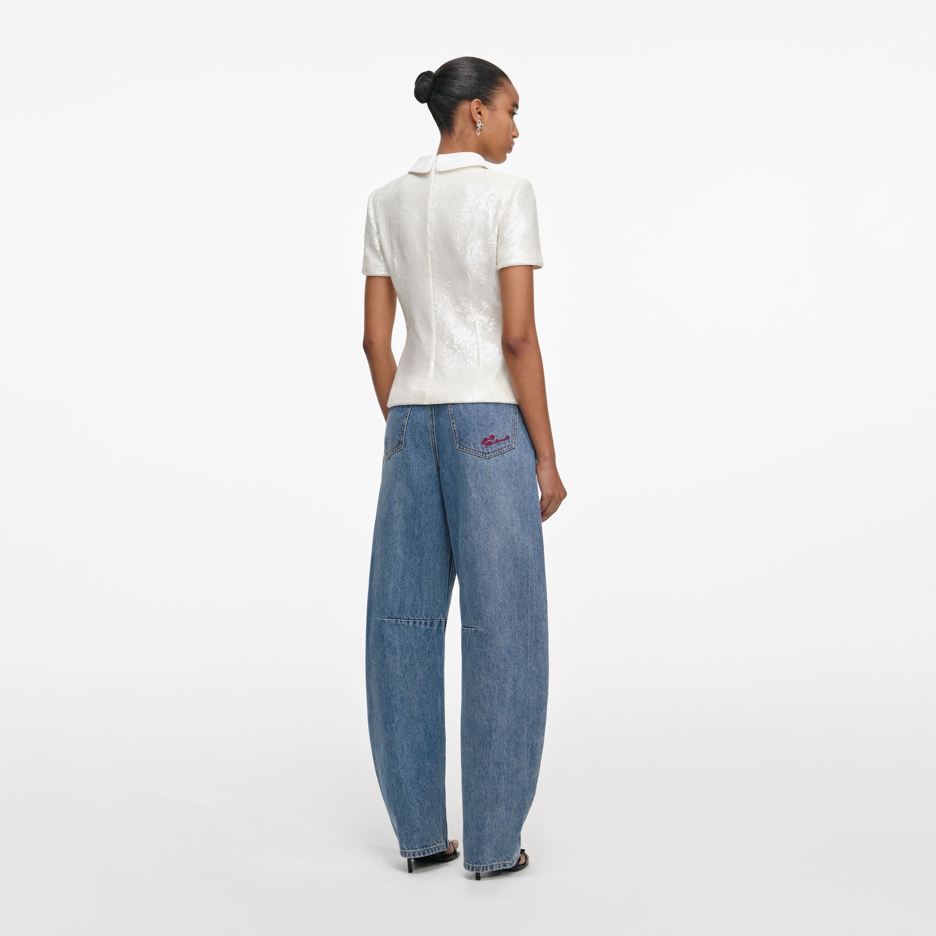 Back view of a woman wearing the White Sequin Tailored Top