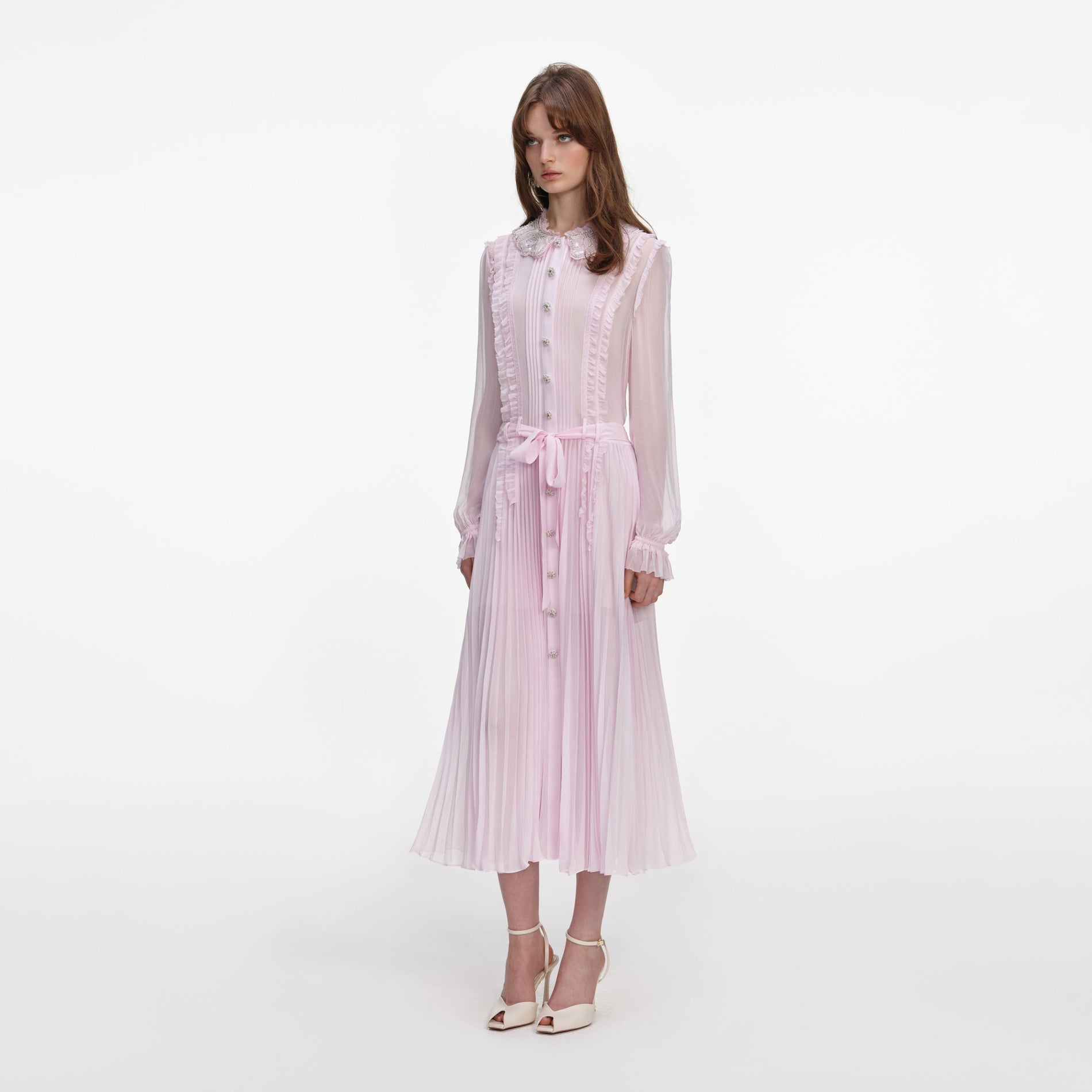 Side view of a woman wearing the Pink Pleated Georgette Midi Dress