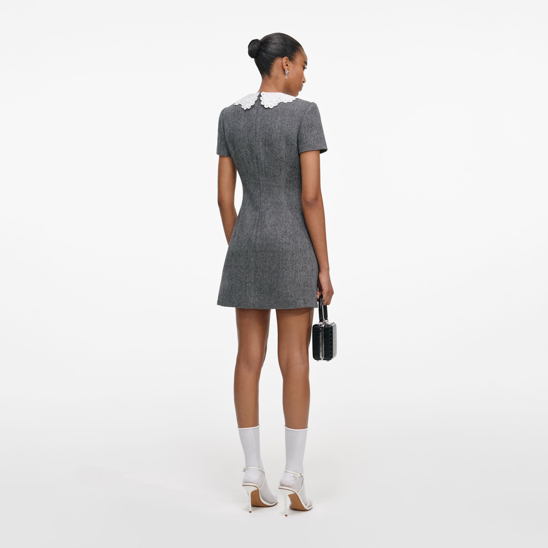 Back view of a woman wearing the Grey Herringbone Collared Mini Dress
