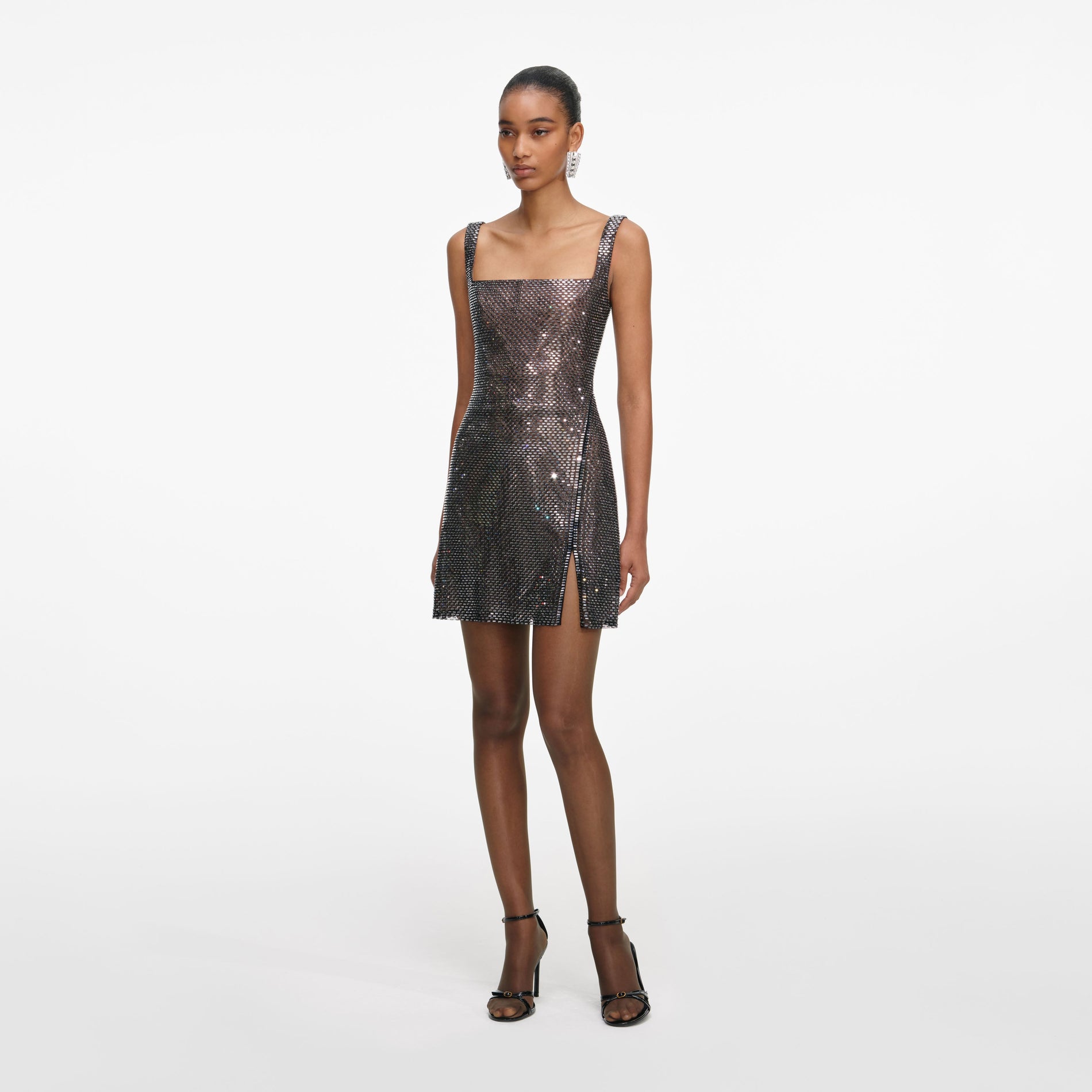 Side view of a woman wearing the Gunmetal Rhinestone Mesh Mini Dress