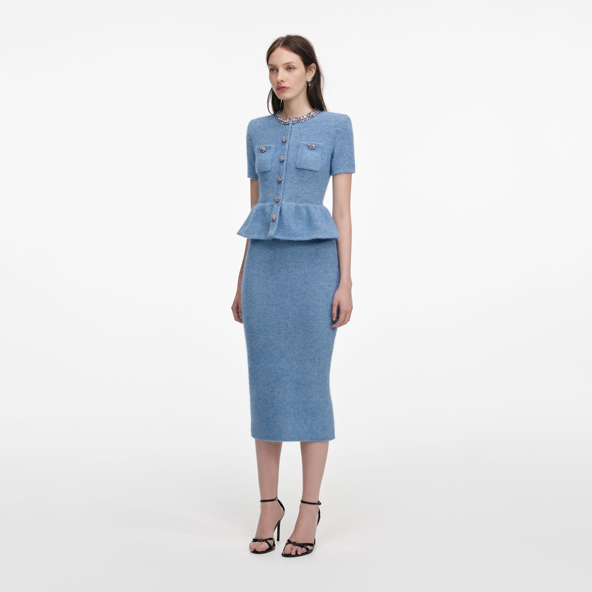 Side view of a woman wearing the Blue Peplum Knit Midi Dress