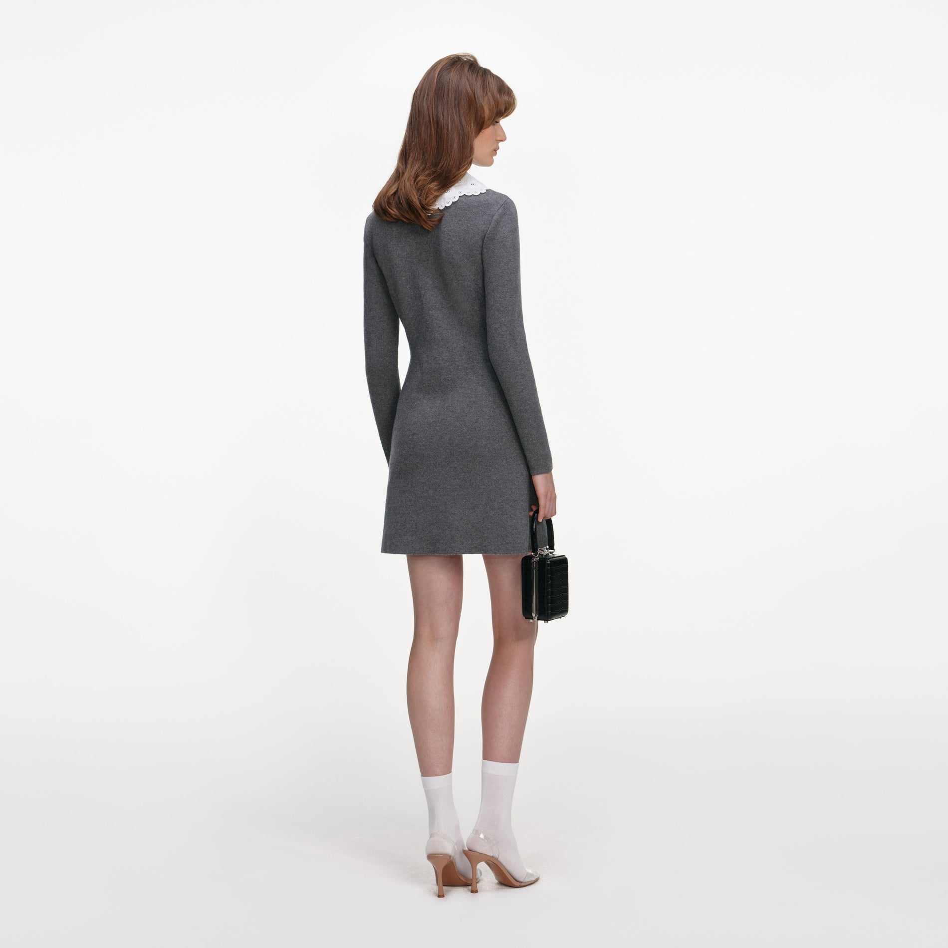 Back view of a woman wearing the Grey Knit Mini Dress