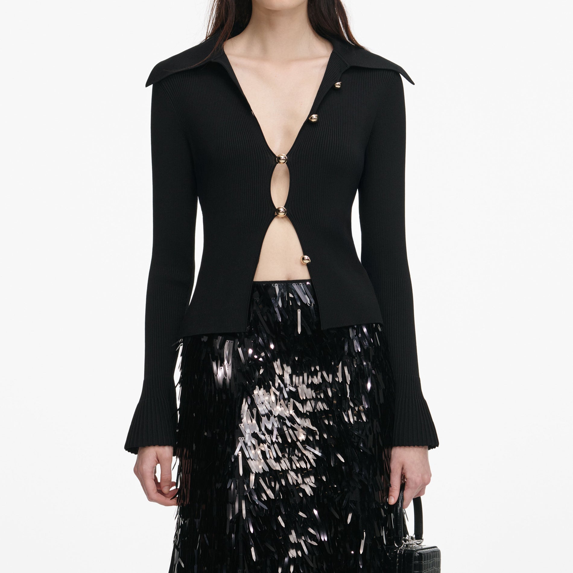 A close up of a woman wearing the Black Button Down Knit Top