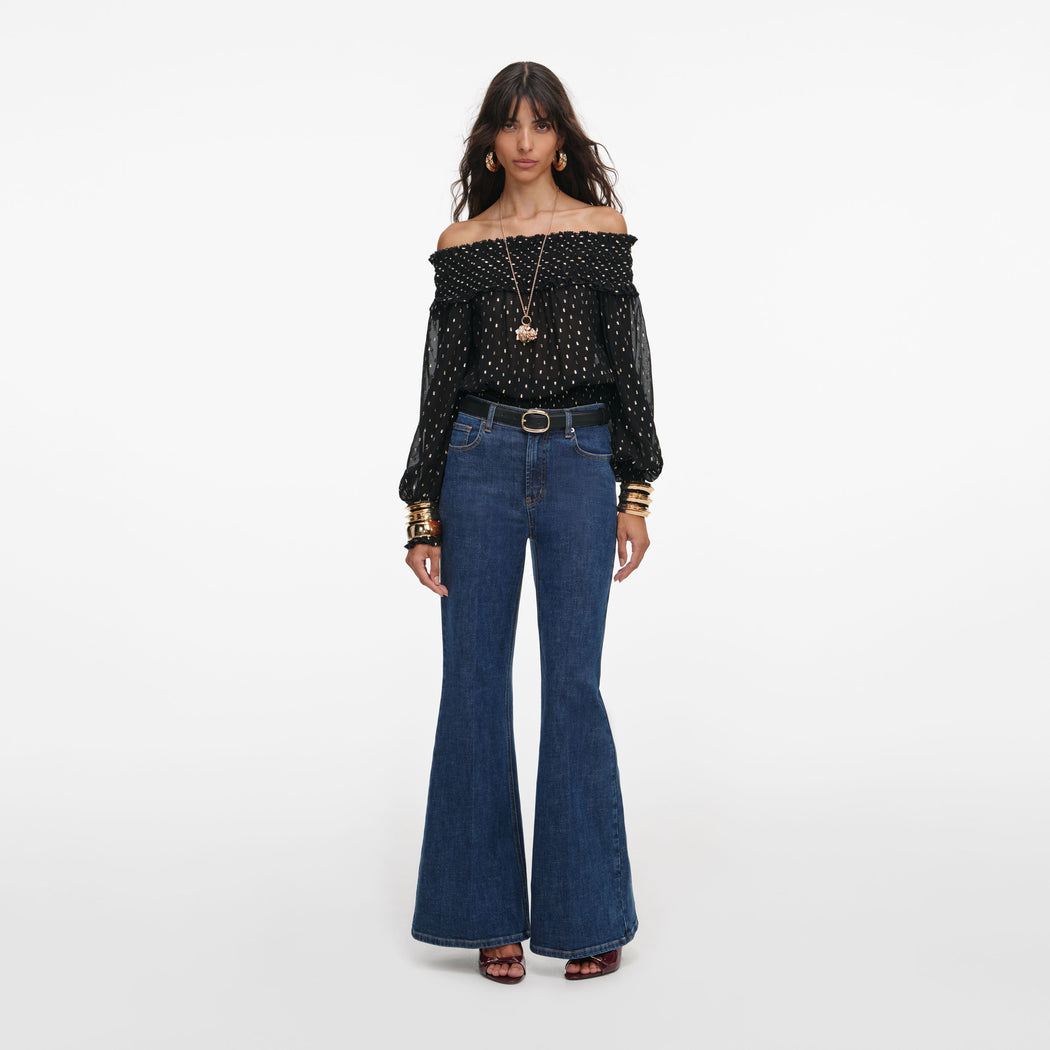 Front view of a woman wearing the Black And Gold Chiffon Top