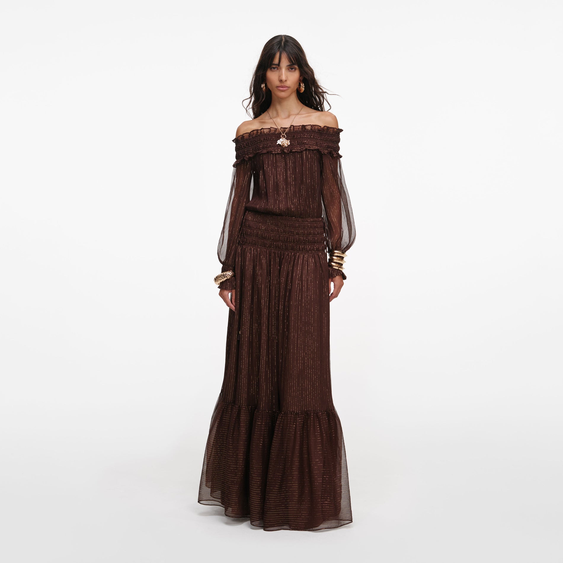 Front view of a woman wearing the Brown Georgette Off Shoulder Maxi Dress