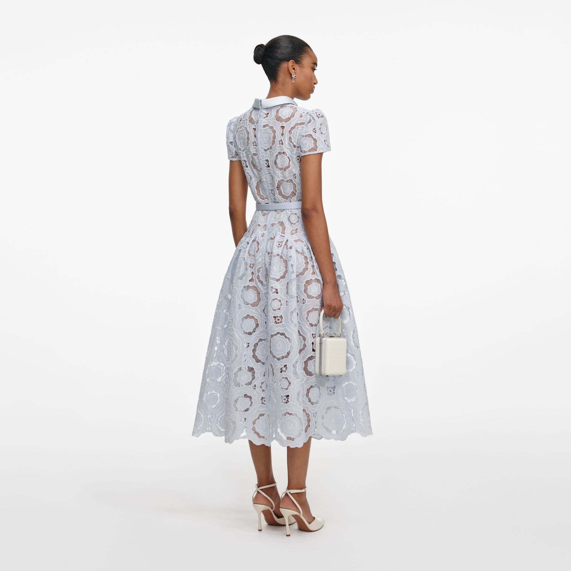 Back view of a woman wearing the Blue Floral Lace Midi Dress
