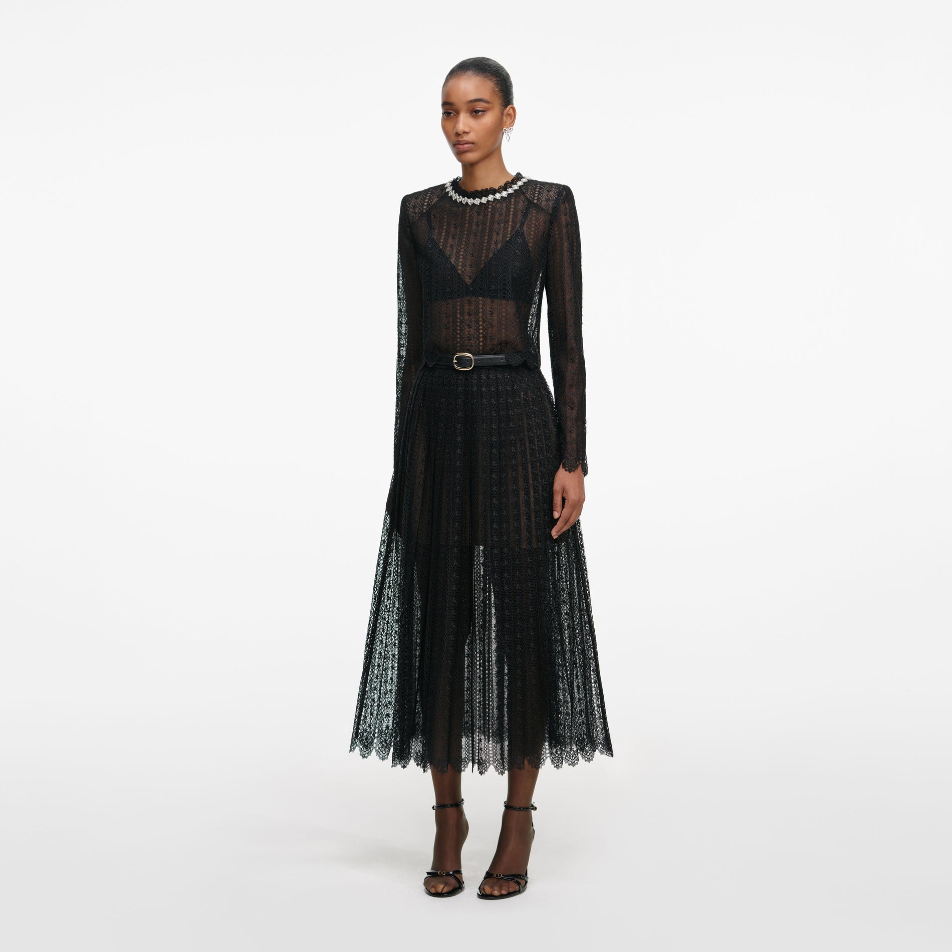 Side view of a woman wearing the Black Organza Lace Midi Skirt
