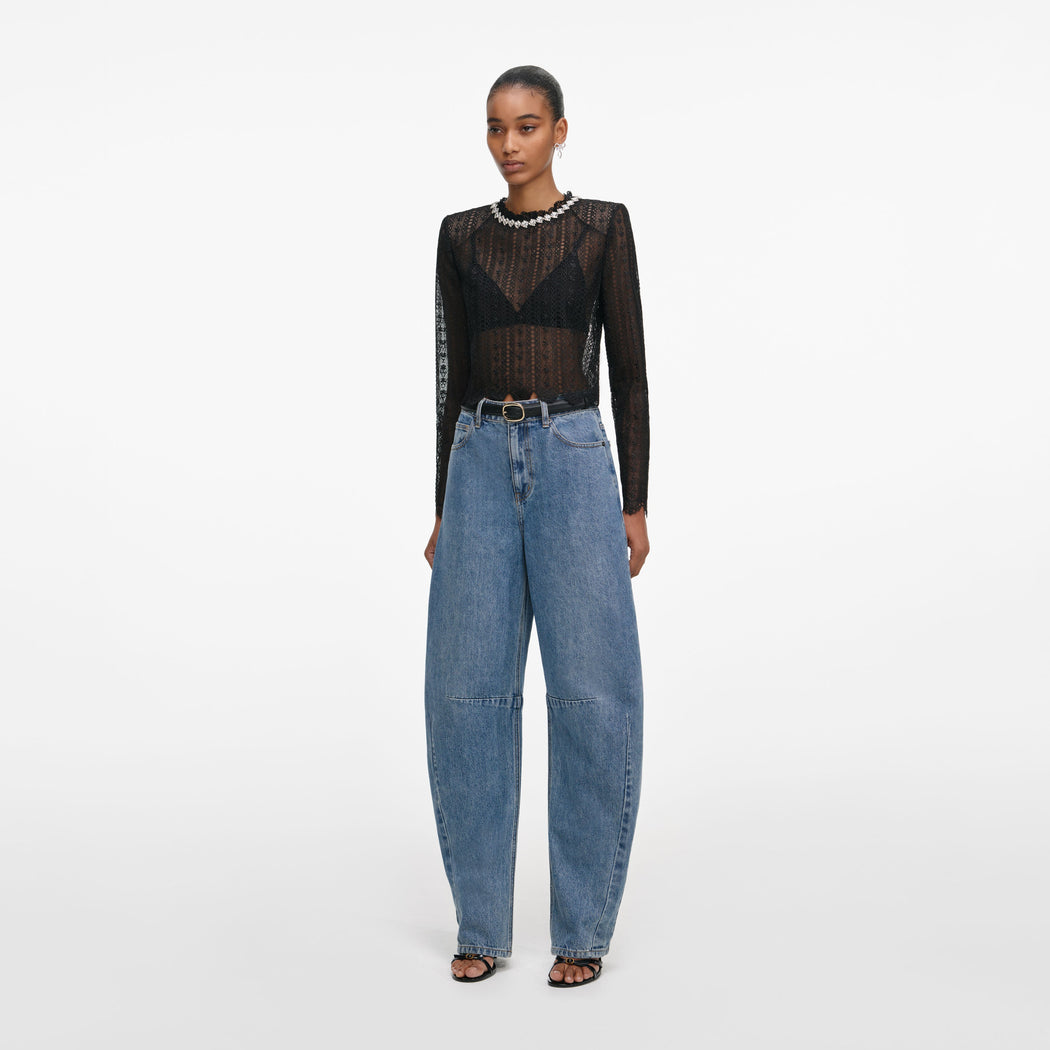 Side view of a woman wearing the Black Organza Lace Top